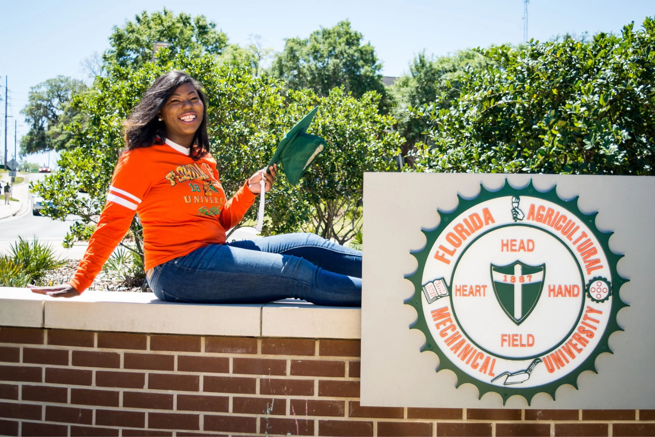  Graduate Shaperlya posing on new FAMU roundabout in a casual university tshirt and jeans. 