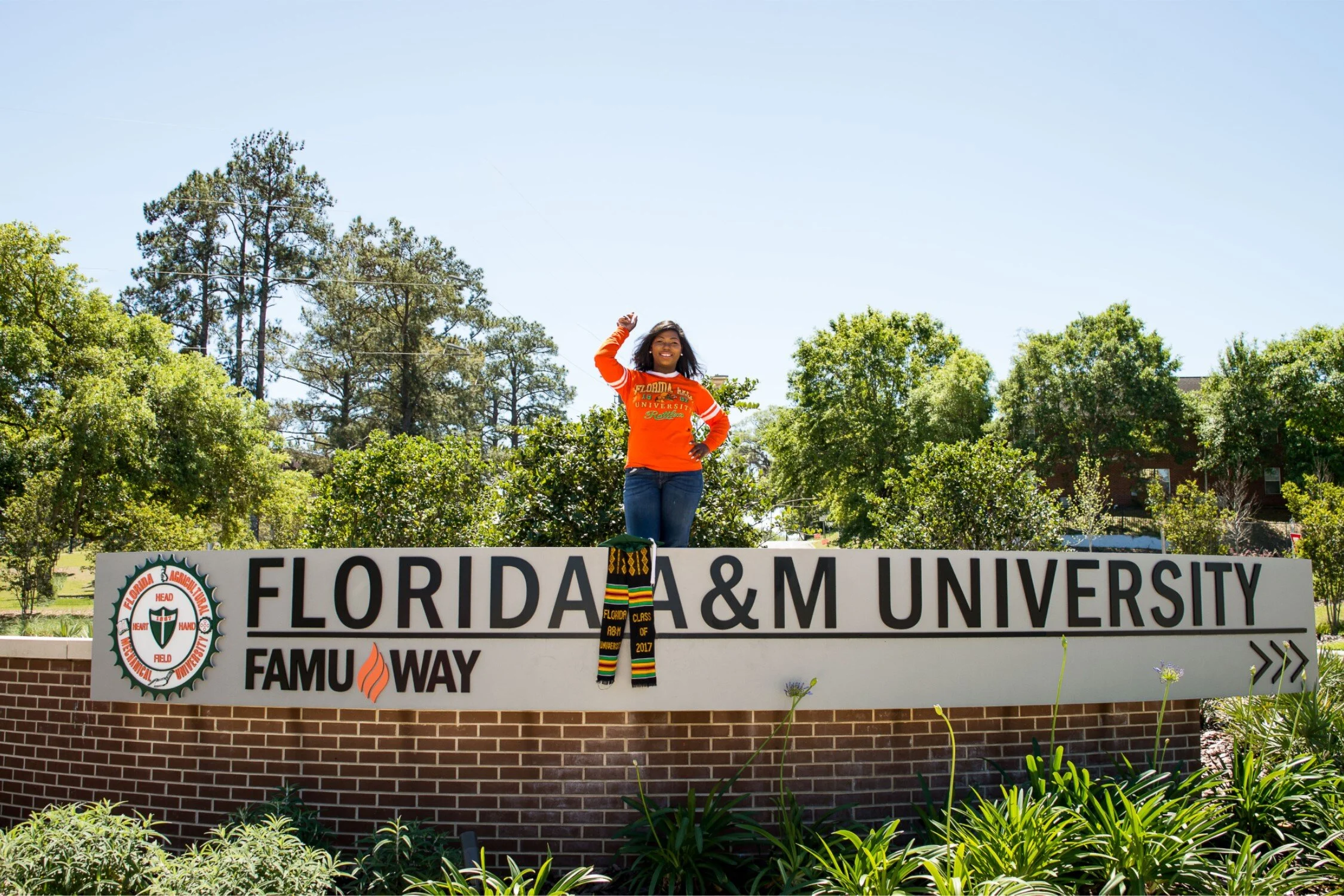  Graduate Shaperlya giving the rattler strike on new FAMU roundabout in a casual university tshirt and jeans. 