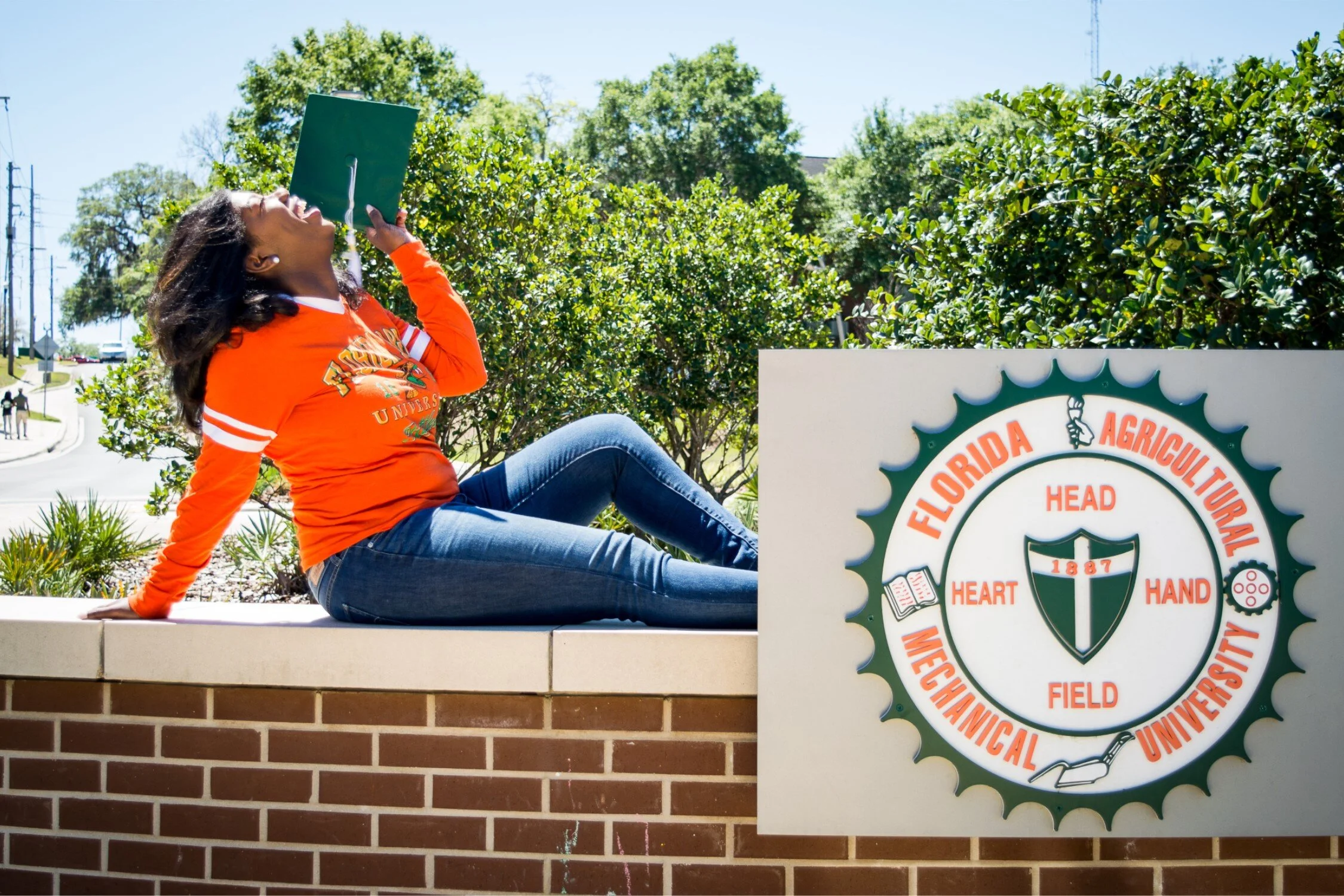  Graduate Shaperlya posing on new FAMU roundabout in a casual university tshirt and jeans. 