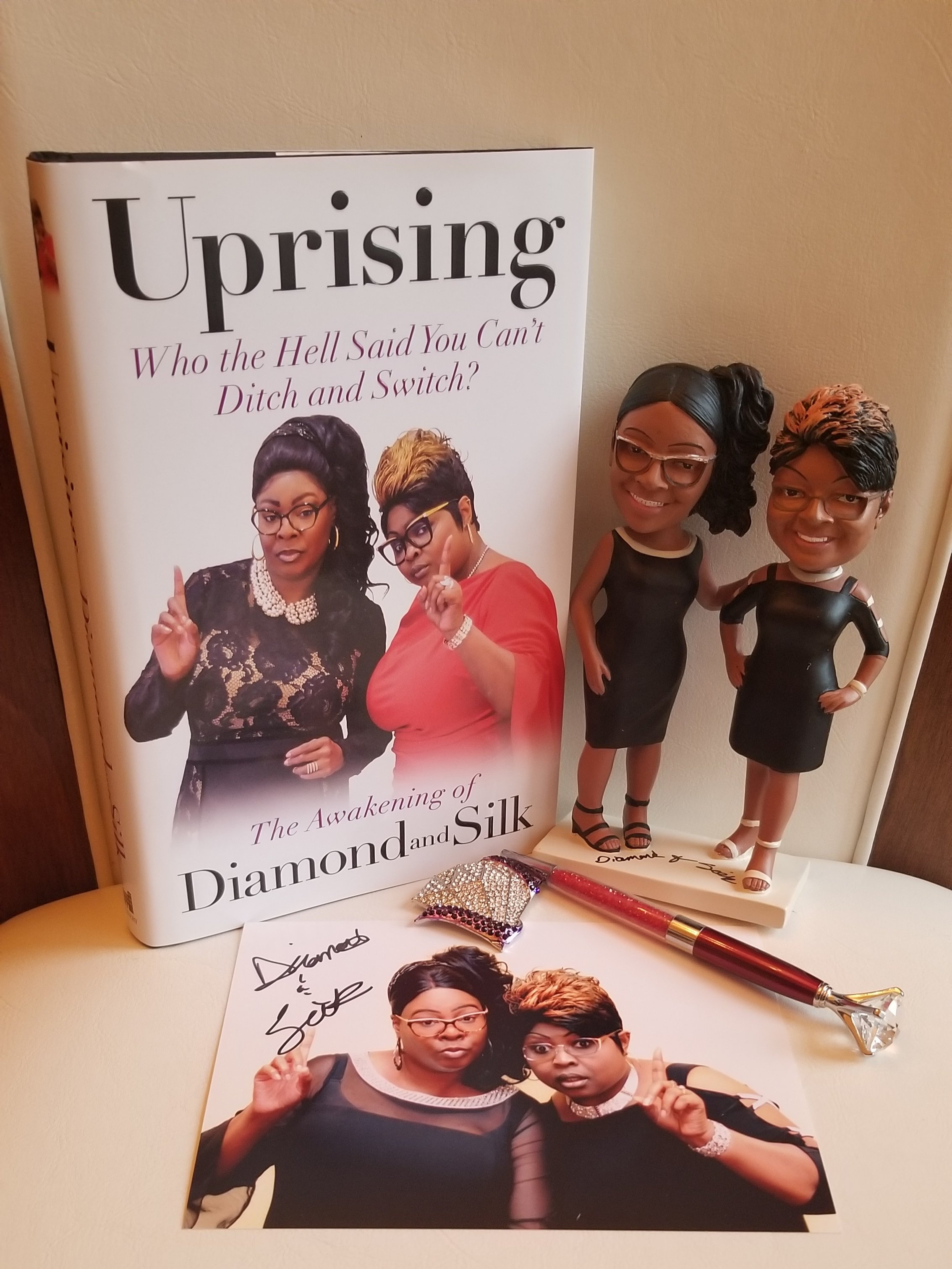 AUTOGRAPH MEMORABILIA BUNDLE: 1 Autograph Bobble Head, 1 Autograph Uprising Book, 1 D&S Brooch Pin, 1 D&S Ink pen, 1 D&S Photo