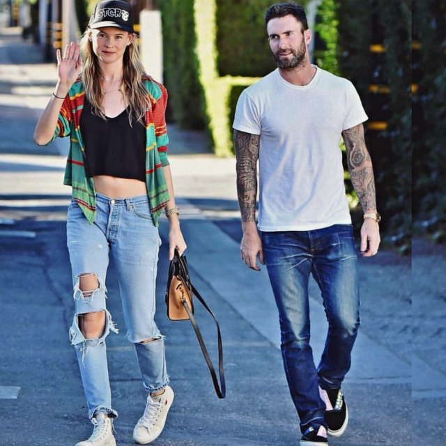 Behati Prinsloo skewed ultra casual this weekend while on a stroll with hubby Adam Levine. The model was spotted hitting her stride with a wave in Converse x Comme des Garcons PLAY Chuck Taylor High Top Sneakers in beige.