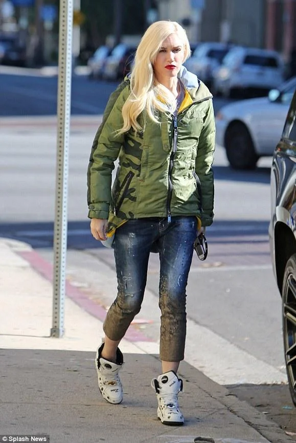 Gwen Stefani did some holiday shopping wearing Dsquared2 Mud Print Crop Jeans , a L.A.M.B. x Burton Oc Insulator Parka, and Melody Ehsani x Reebok Black Top Pumps.