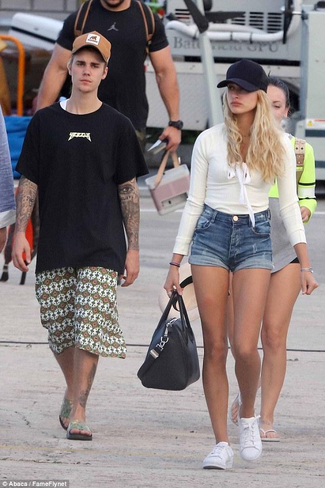 Hailey Baldwin took a holiday walk with Justin Bieber wearing One Teaspoon Harlets Shorts in Pure Blue and adidas Originals Superstar Sneakers.