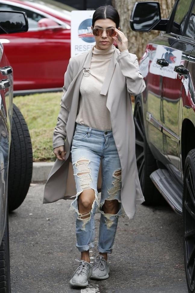Kourtney Kardashian brought some sneaker style slayage in Citizens of Humanity Avedon Slick Skinny Jeans in Comet and Yeezy 350 Boost Sneakers in Moonrock.