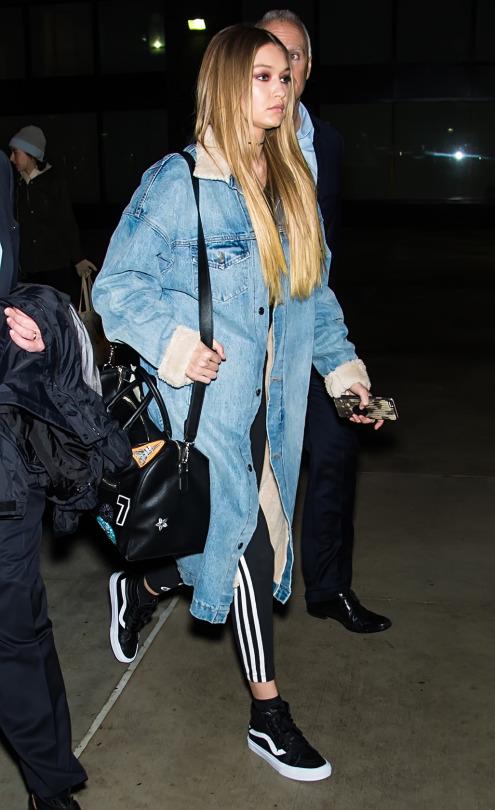 GiGi Hadid made a mad dash in a fresh pair of Vans Sk8-Hi sneaks and adidas Originals 3-Stripe leggings.