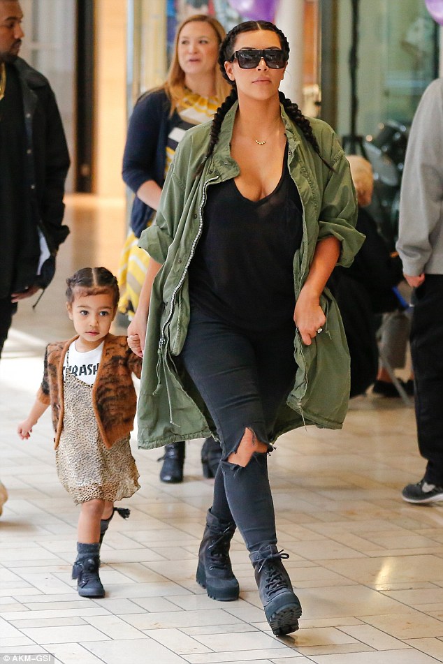 We're not huge fans of the Yeezy 950 boot, but Kim Kardashian made them look amazing as she, North, and hubby Kanye made a trek to the mall for some Build-A-Bear fun. Very cute.