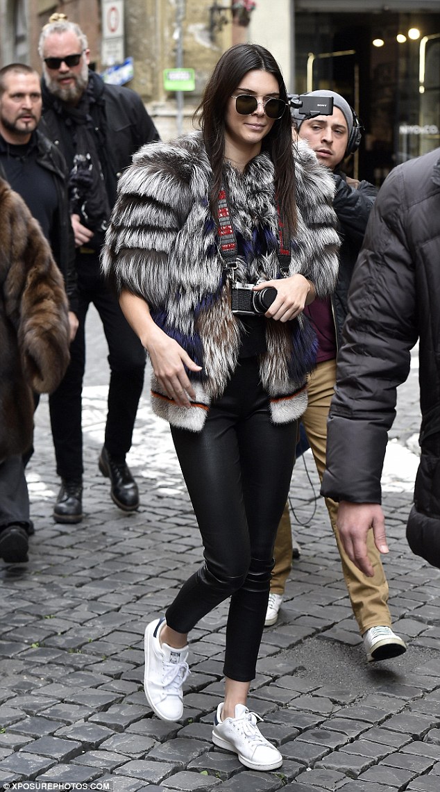 Kendall Jenner took to the streets of Rome, Italy to explore and get her tourist on in Stan Smith sneakers by adidas Originals, JBrand L8007 Edita Leather leggings, and a furry jacket paired expertly with the Asahi Pentax Vintage K1000 camera.