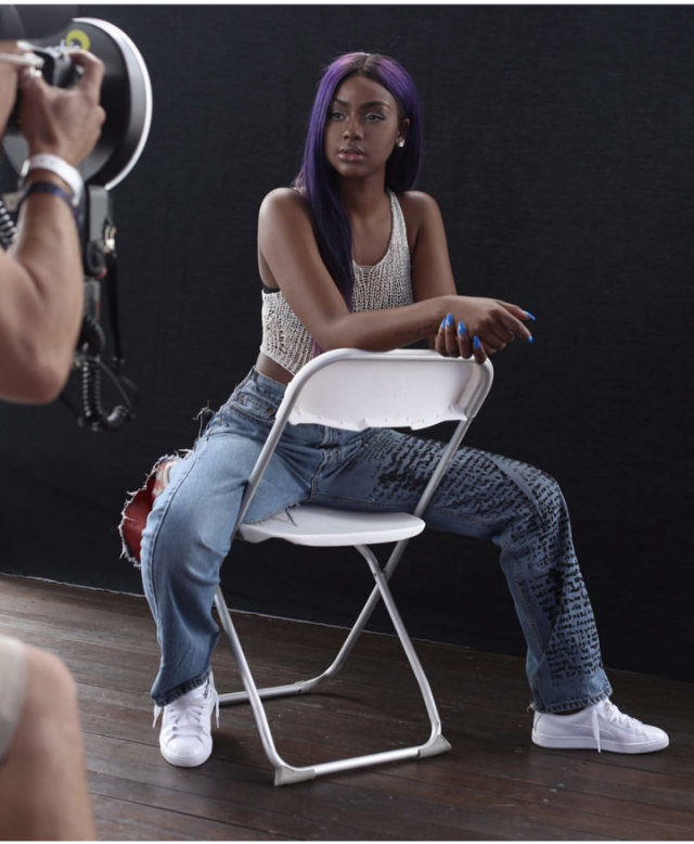 Justine Skye was posed to perfection for a laid back shoot in custom boyfriend jeans, a knit tank, and a fresh pair of Puma Basket Classics in Metal White.