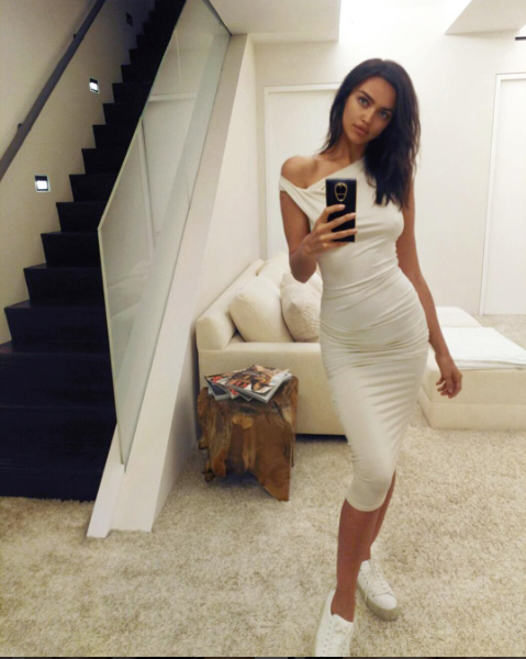 Irina Shayk took a minute for a mirror selfie wearing Saint Laurent Court Classic Leather Sneakers and a Bebe Shirred Midi Dress .