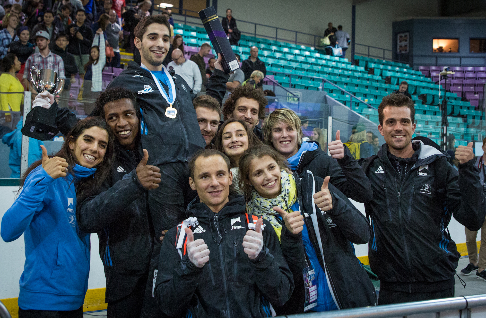 Team France celebrates over Alban Levier's first place win at Toronto's International Federation of Sport Climbing's World Bouldering Cup.