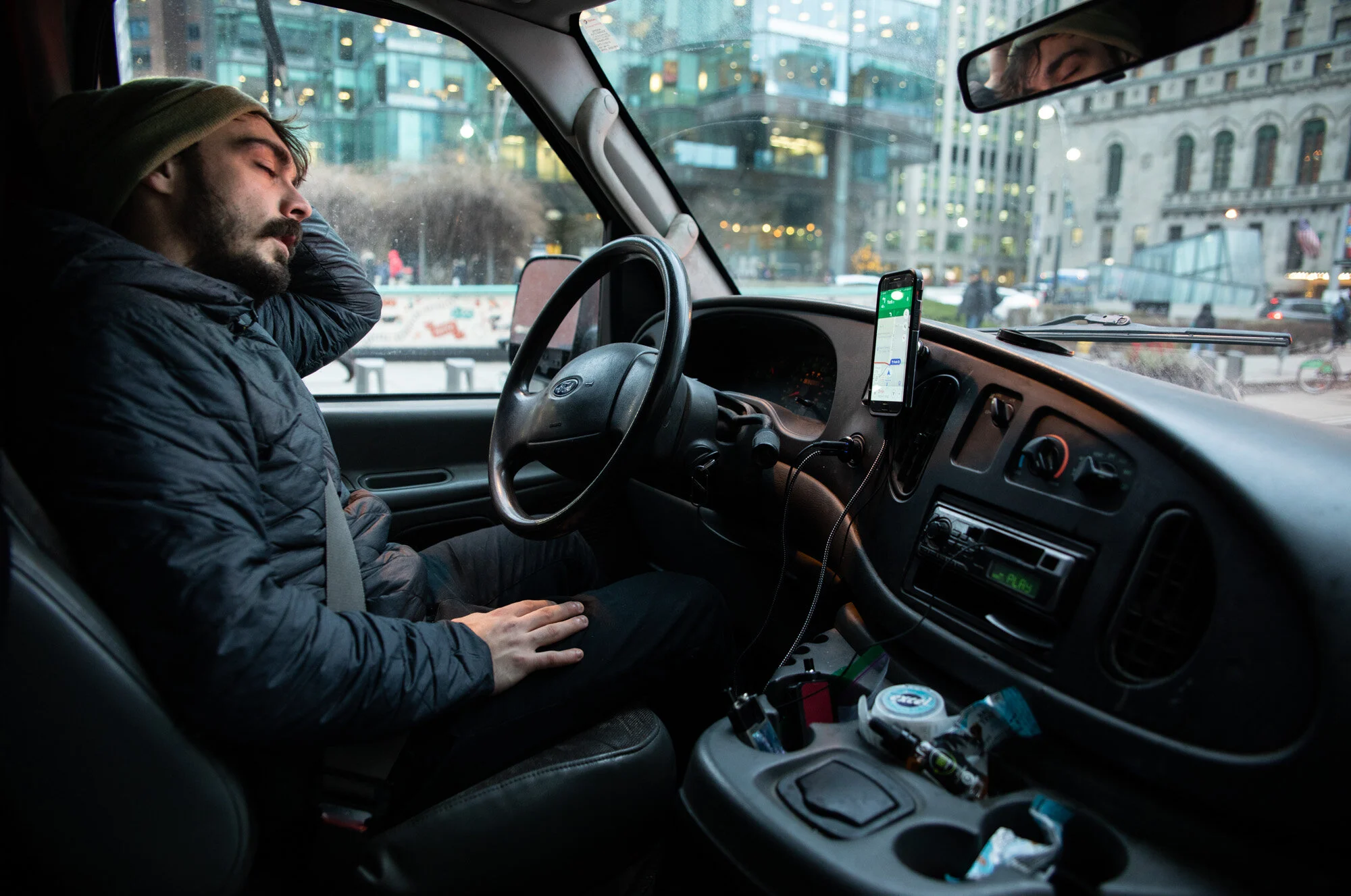  [TORONTO, Ontario] - Max Schneider, 26, takes a moment to rest while on his courier job on December 17, 2018. Originally from Germany, his dream is to live and travel across Canada. He spends Monday to Friday delivering packages using his van home. 