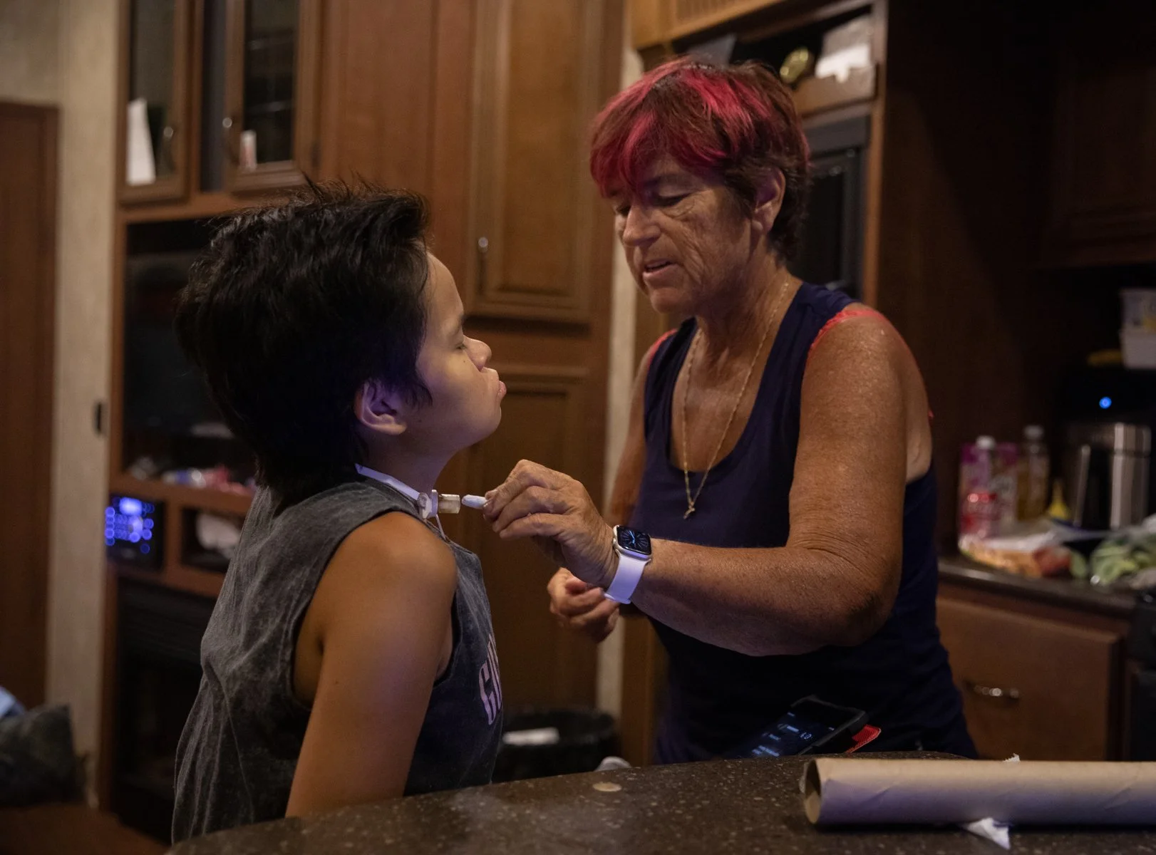  Gail helps Ruth clean his tracheostomy tube after he coughs. 