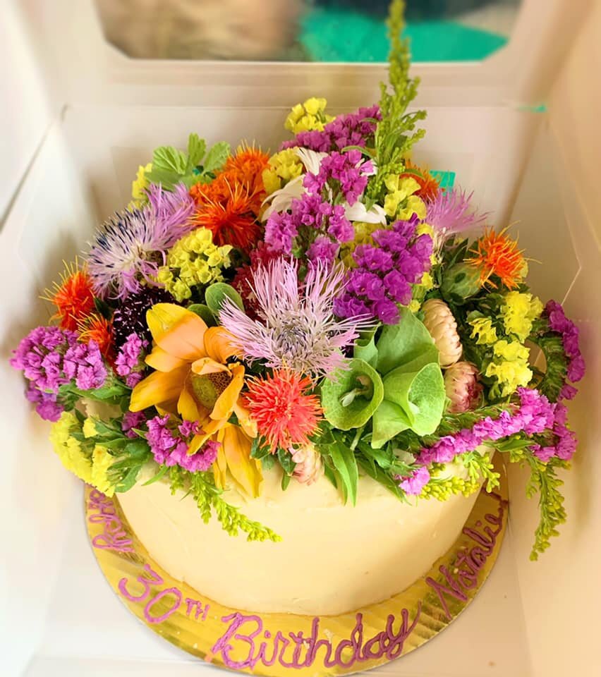 lavender cardamom vanilla cake with lemon buttercream frosting and topped with local, seasonal wildflowers