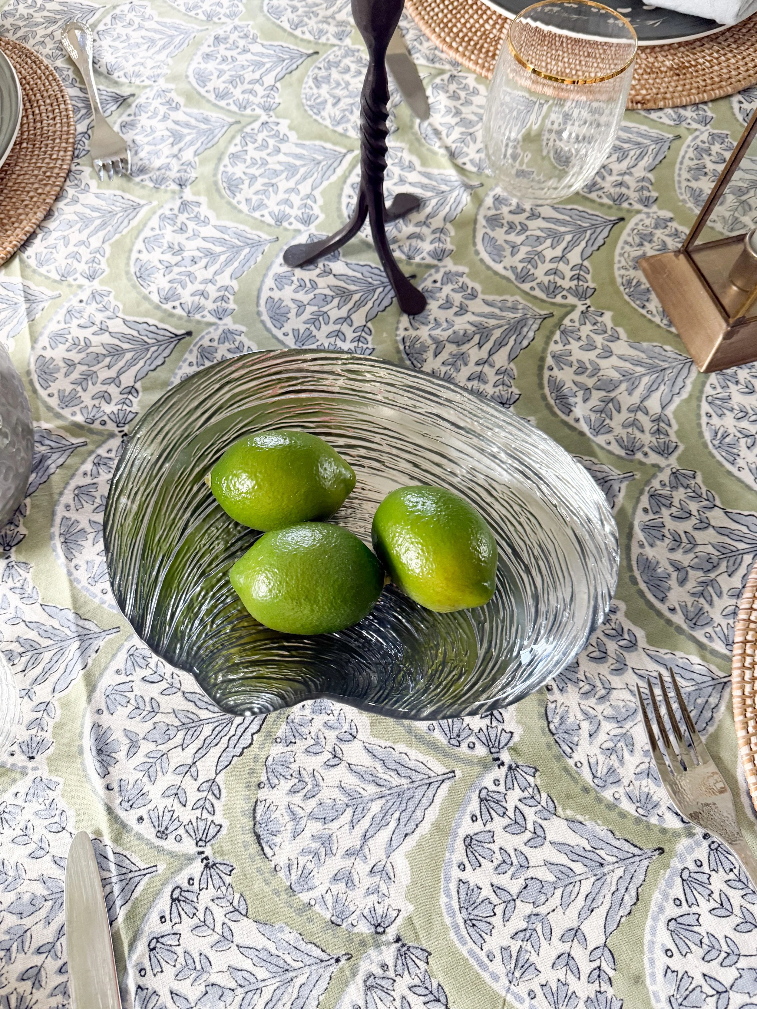 Glass bowl with fresh limes styled as a simple McGee and Co tablescape detail on a neutral dining table