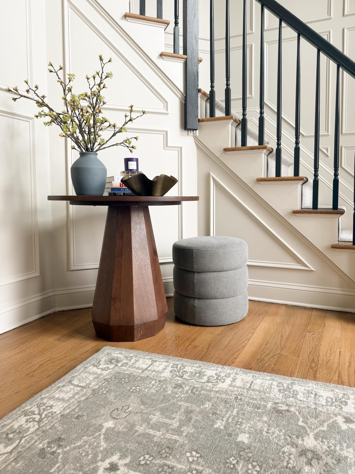 One of my favorite entryway transformations and proof that a can of paint and some trim can go a long way! We trimmed out this entryway and upstairs hallway, painted it the perfect neutral (BM Edgecomb Gray) and installed a statement chandelier and a