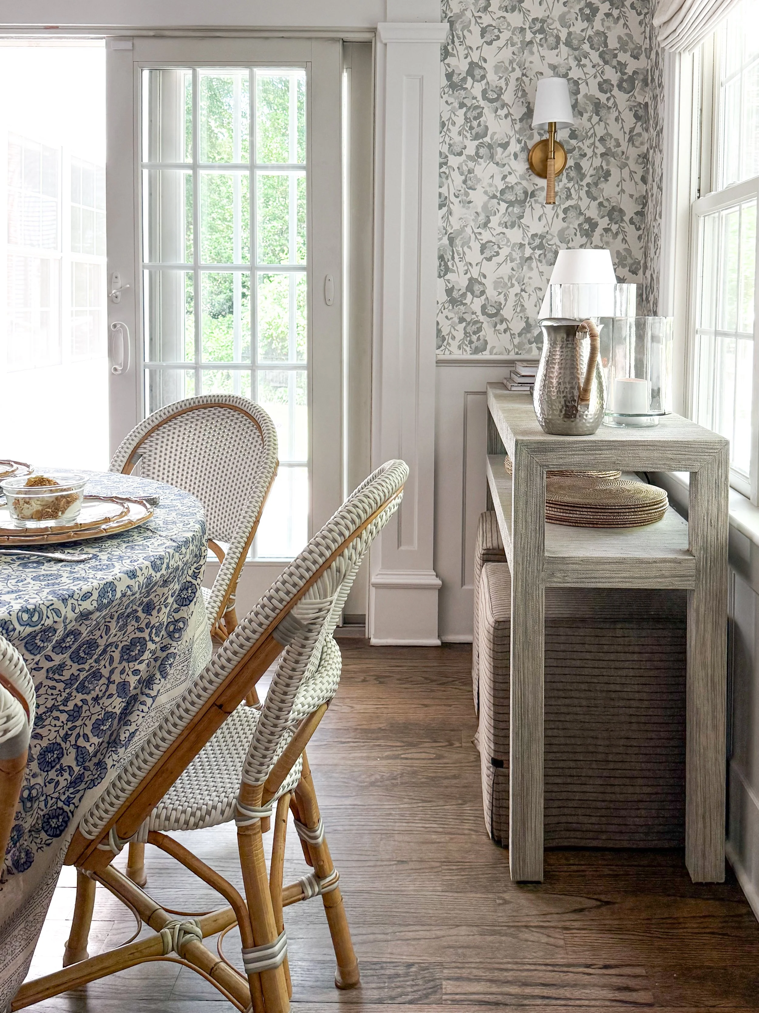 Greenery centerpiece in white ceramic vase surrounded by blue glassware and layered dinnerware on a McGee & Co inspired summer tablescape for everyday entertaining.