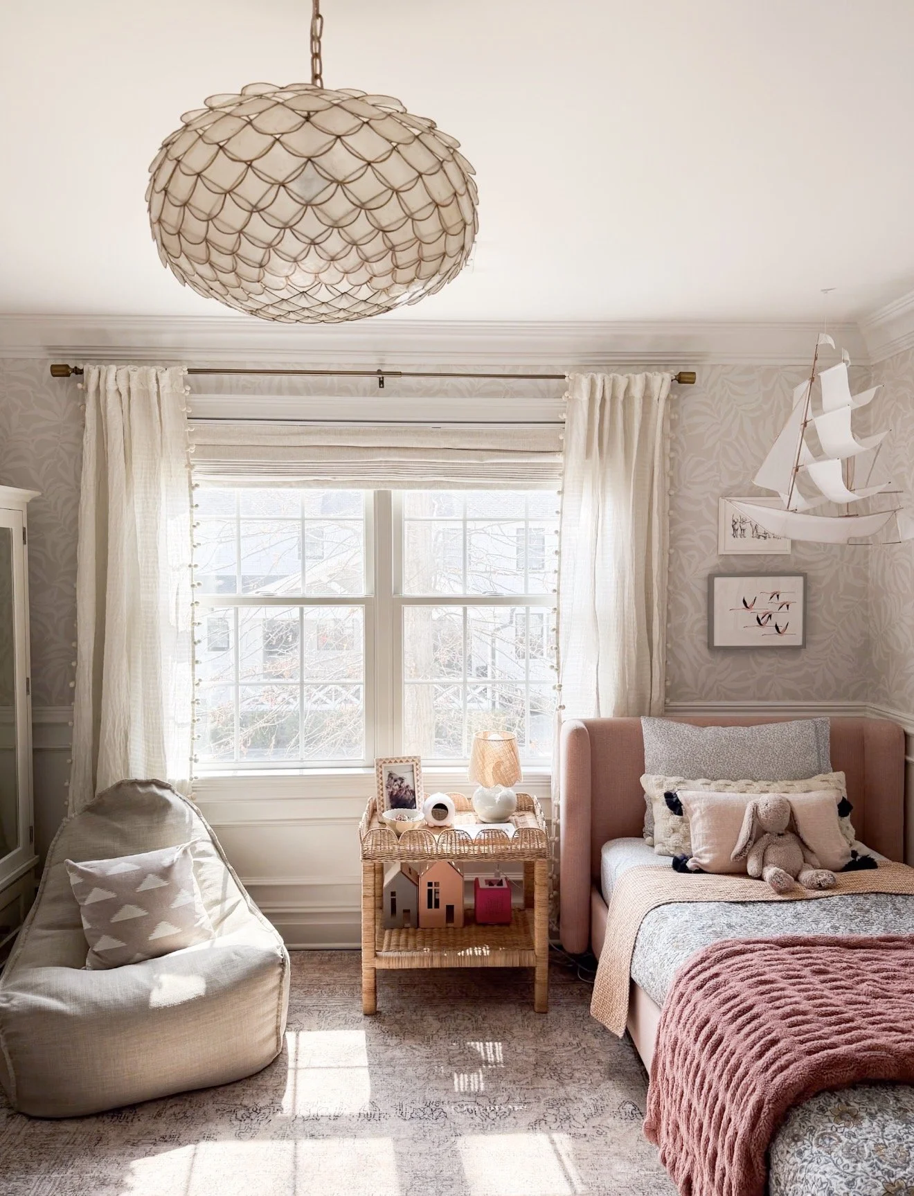 Serena & Lily Scallop Capiz Chandelier hanging in a nursery with soft neutral decor and natural textures.