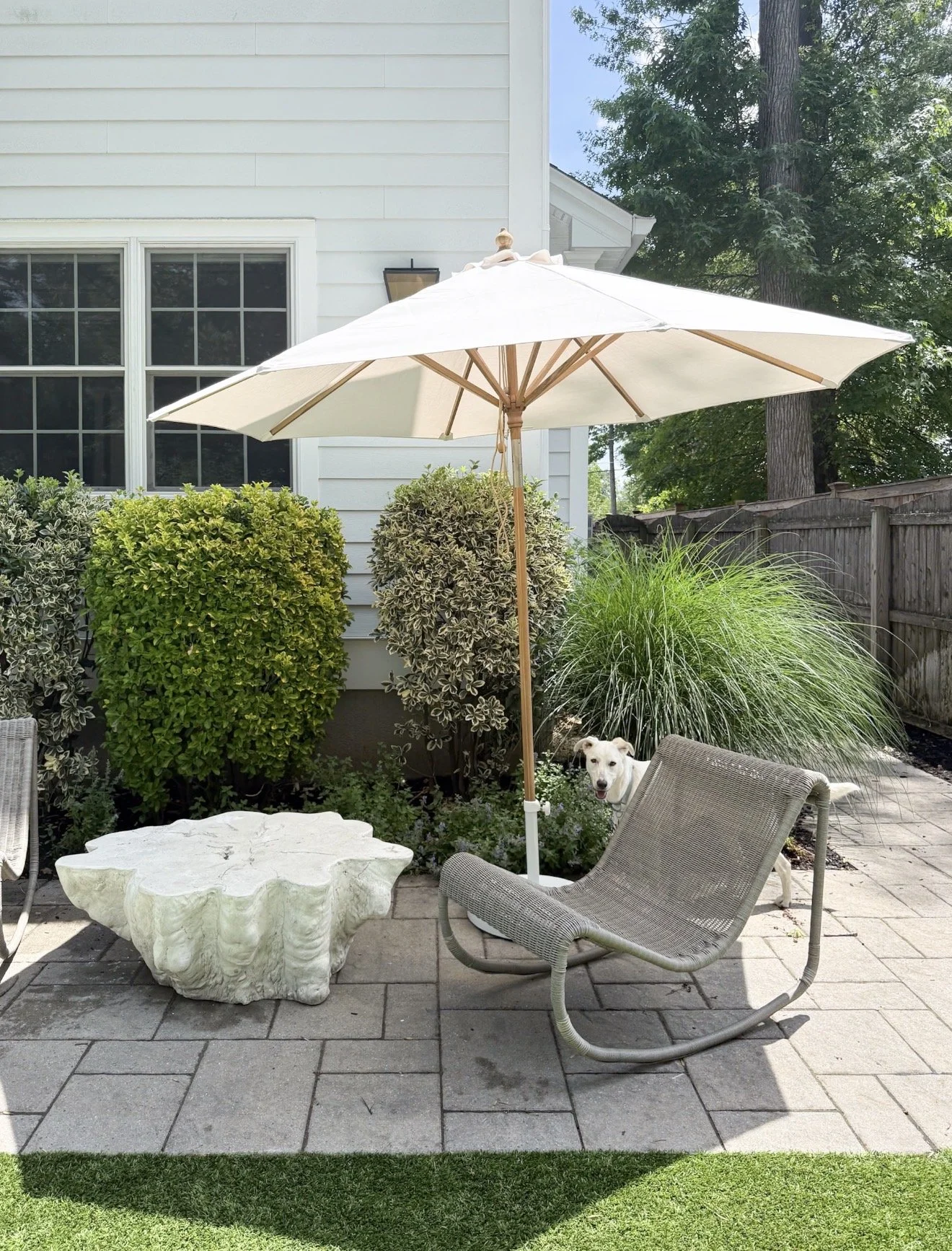 Serena & Lily teak patio umbrella shading an outdoor seating area with timeless coastal-inspired design.