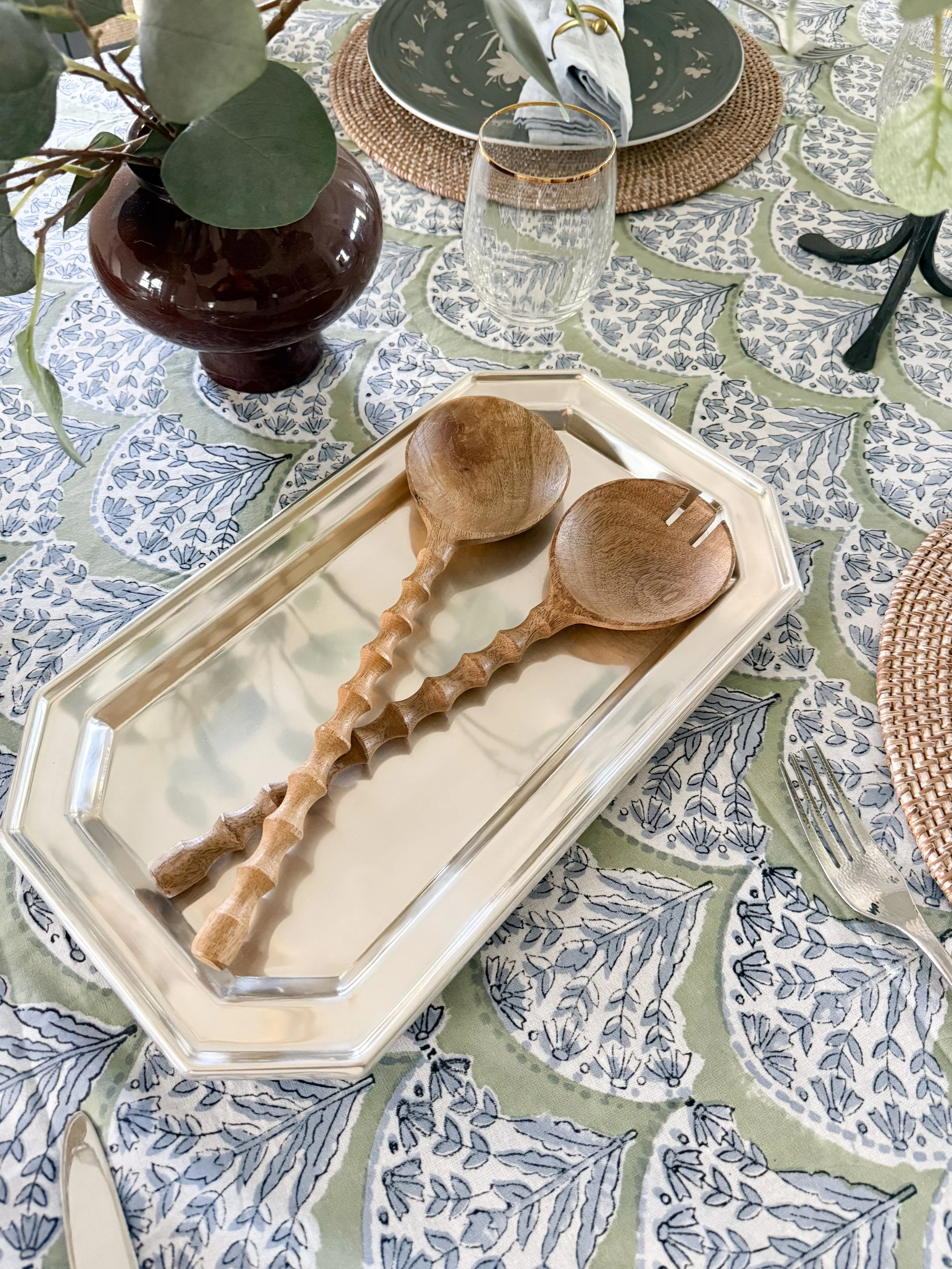 McGee and Co tablescape detail with black lanterns and woven placemat on a neutral dining table