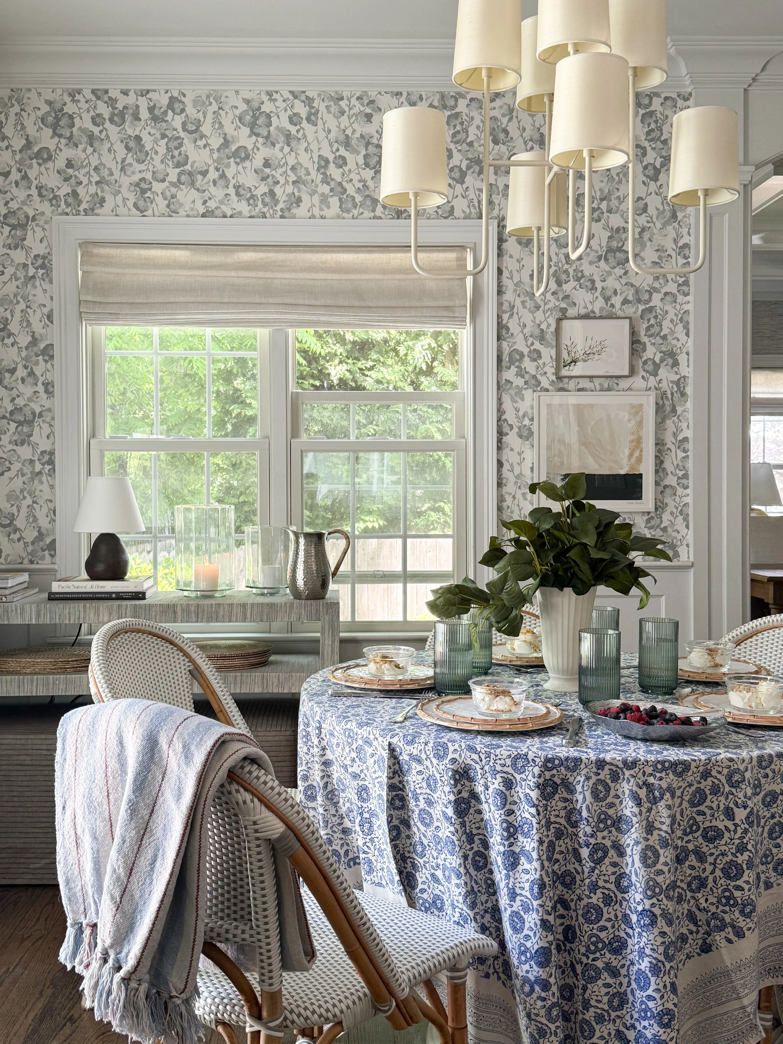 McGee & Co inspired summer tablescape featuring a blue and white patterned tablecloth, layered dinnerware, textured glassware, greenery centerpiece, and dining room styling for elegant everyday entertaining.