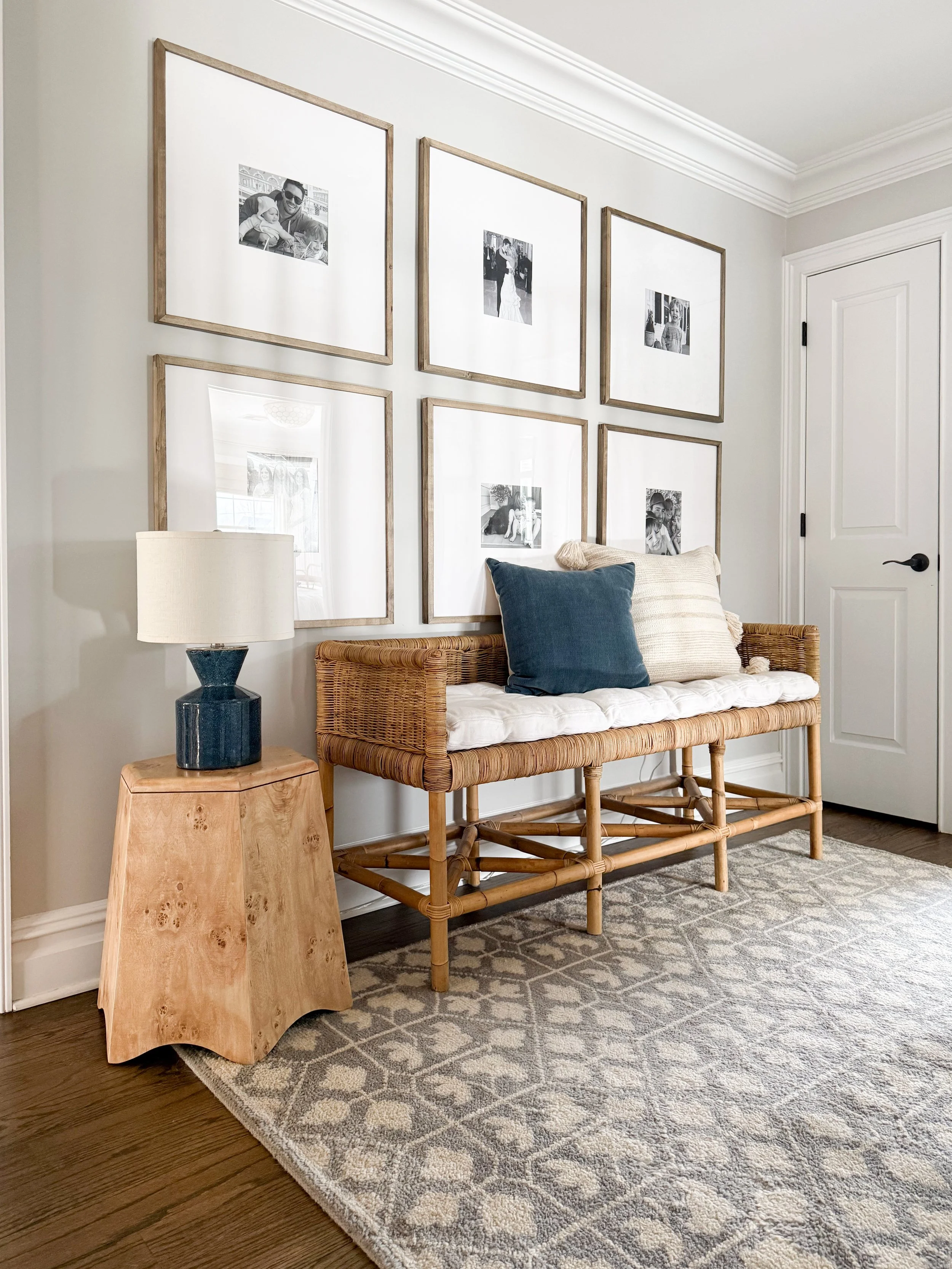 Upstairs hallway with neutral paint colors, white trim molding, wood flooring, and soft natural lighting creating a bright transitional space.