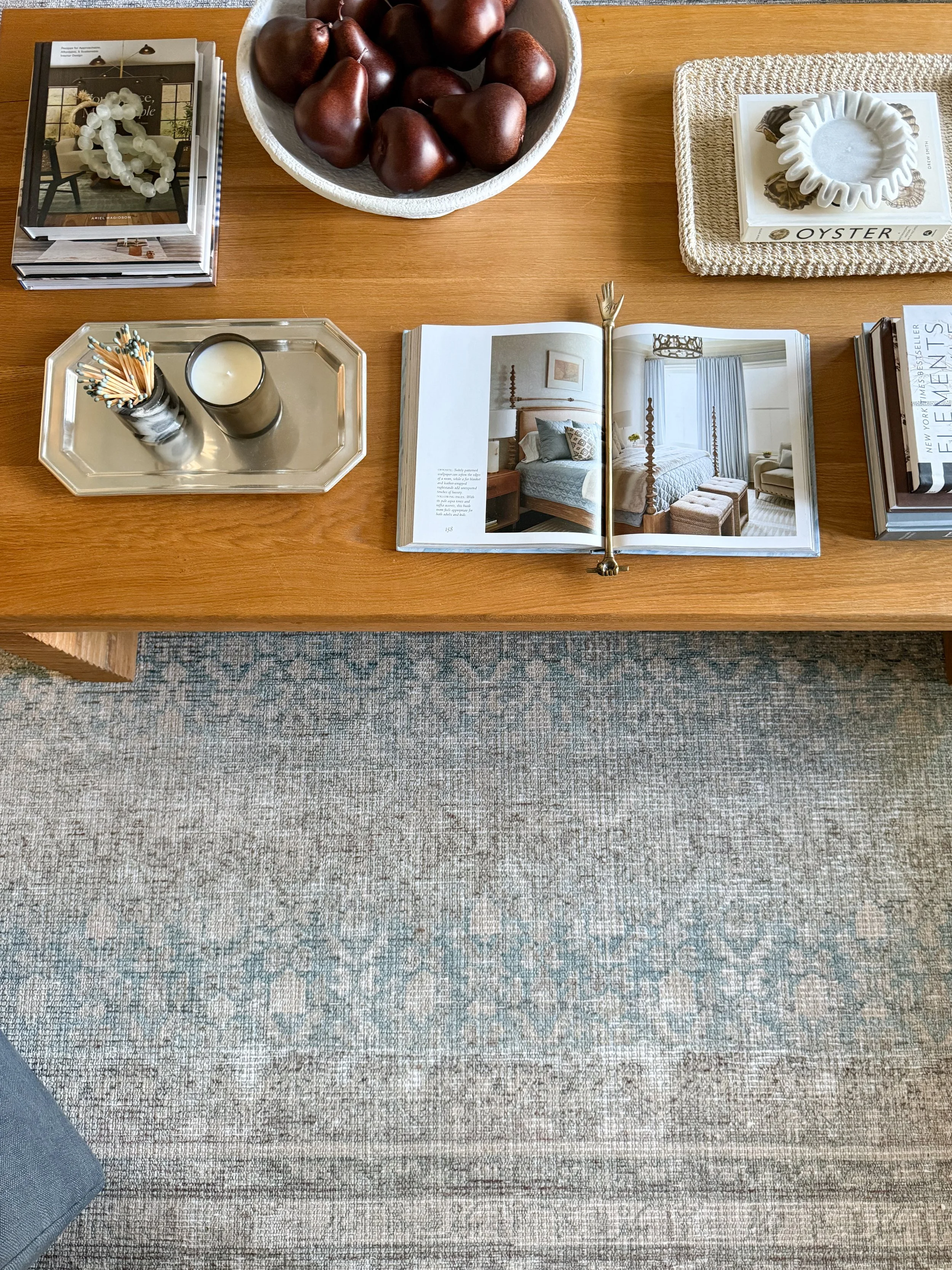Amazon Prime Day home decor find featuring a decorative brass hand bookmark displayed in an open coffee table book.