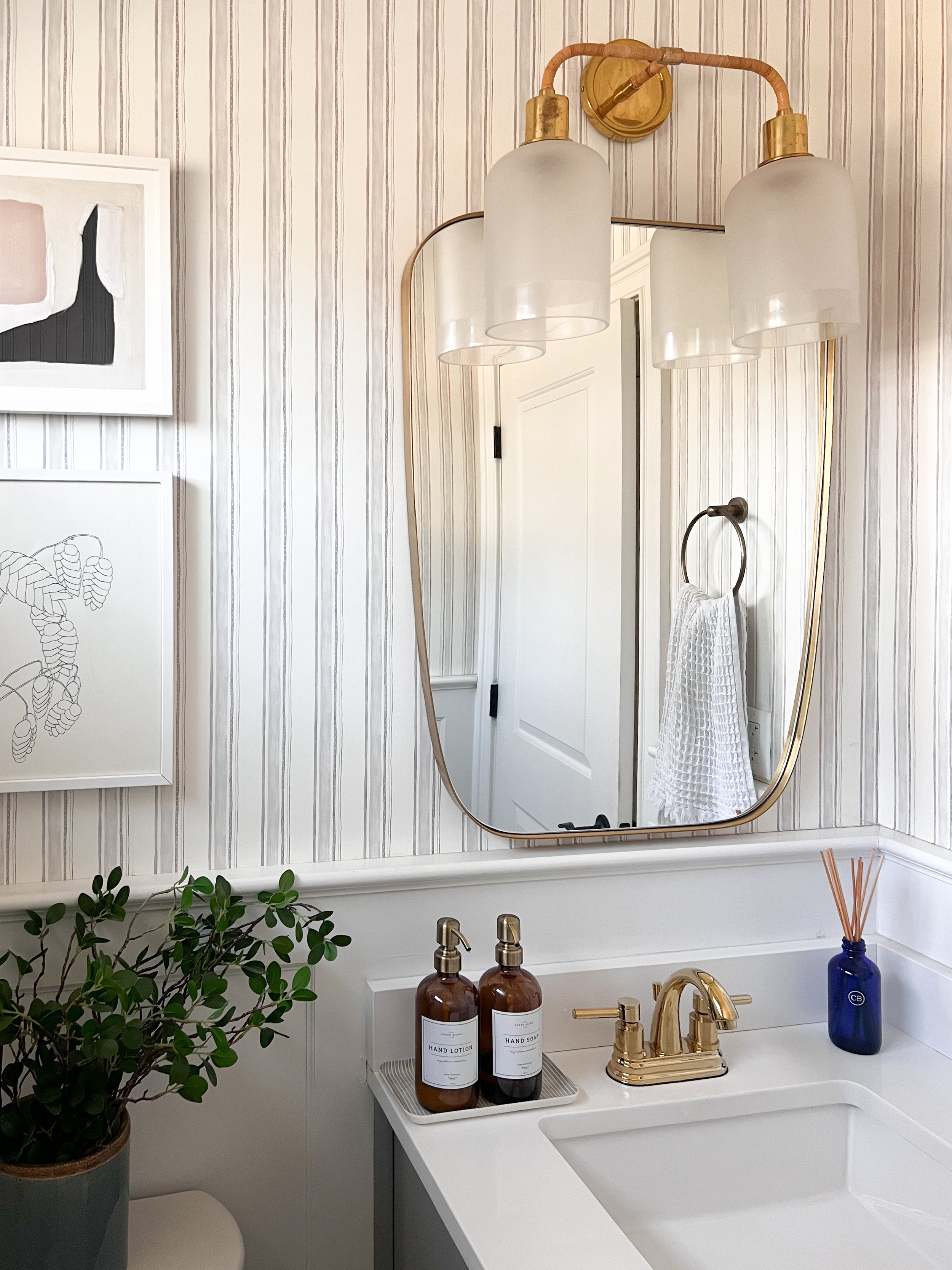 Amazon Prime Day bathroom organization find featuring amber glass soap and lotion dispensers with brass fixtures.