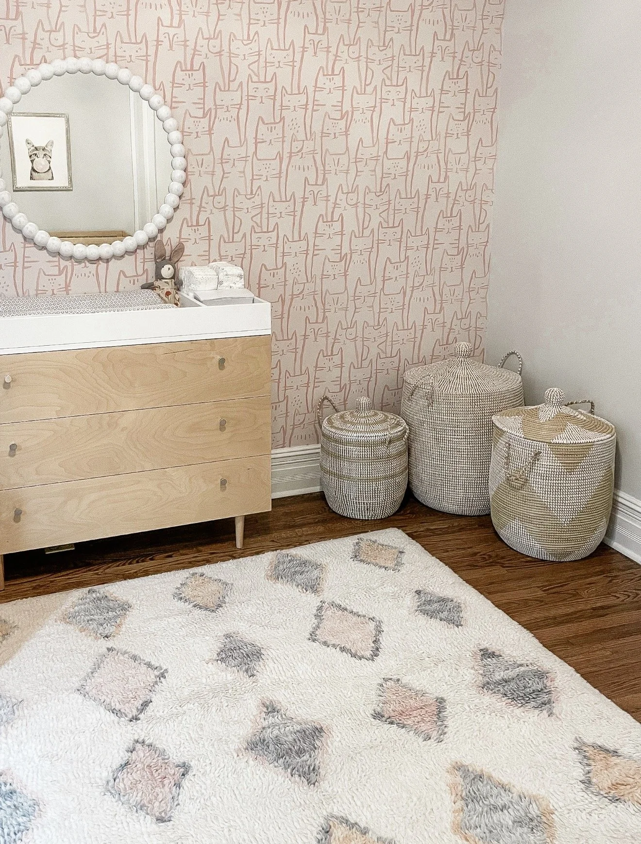 Bedroom nightstand refresh collage featuring a cream textured nightstand, brown table lamp, floral arrangements, decorative books, gold picture frame, patterned boxes, woven tray and classic tabletop clock.