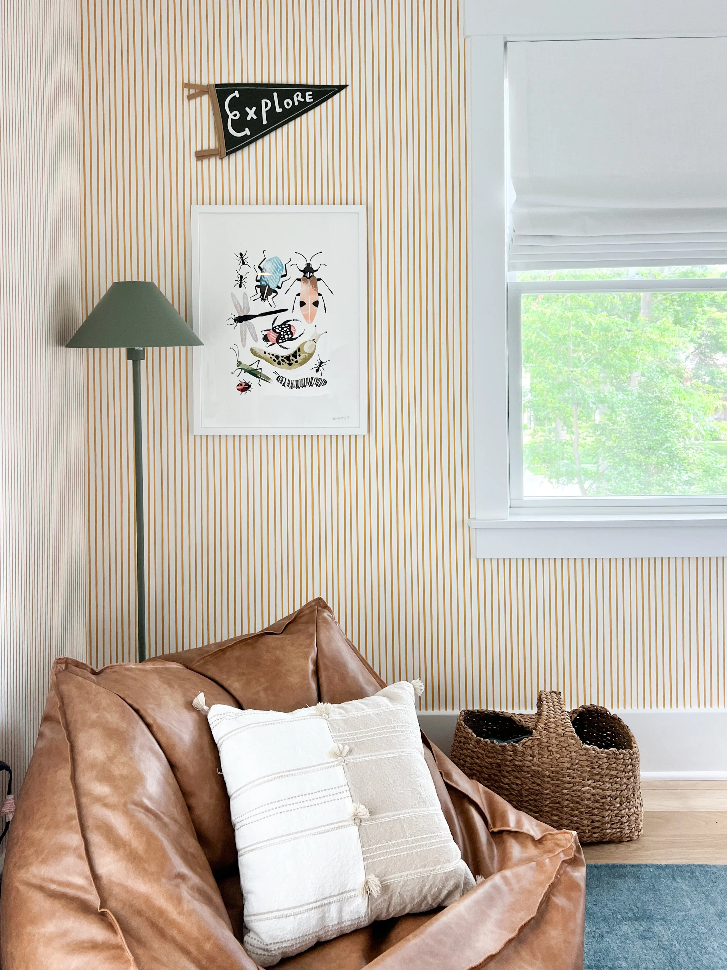 Stylish tween bedroom reading nook featuring an accent chair, cozy pillows, soft lighting, and layered décor.