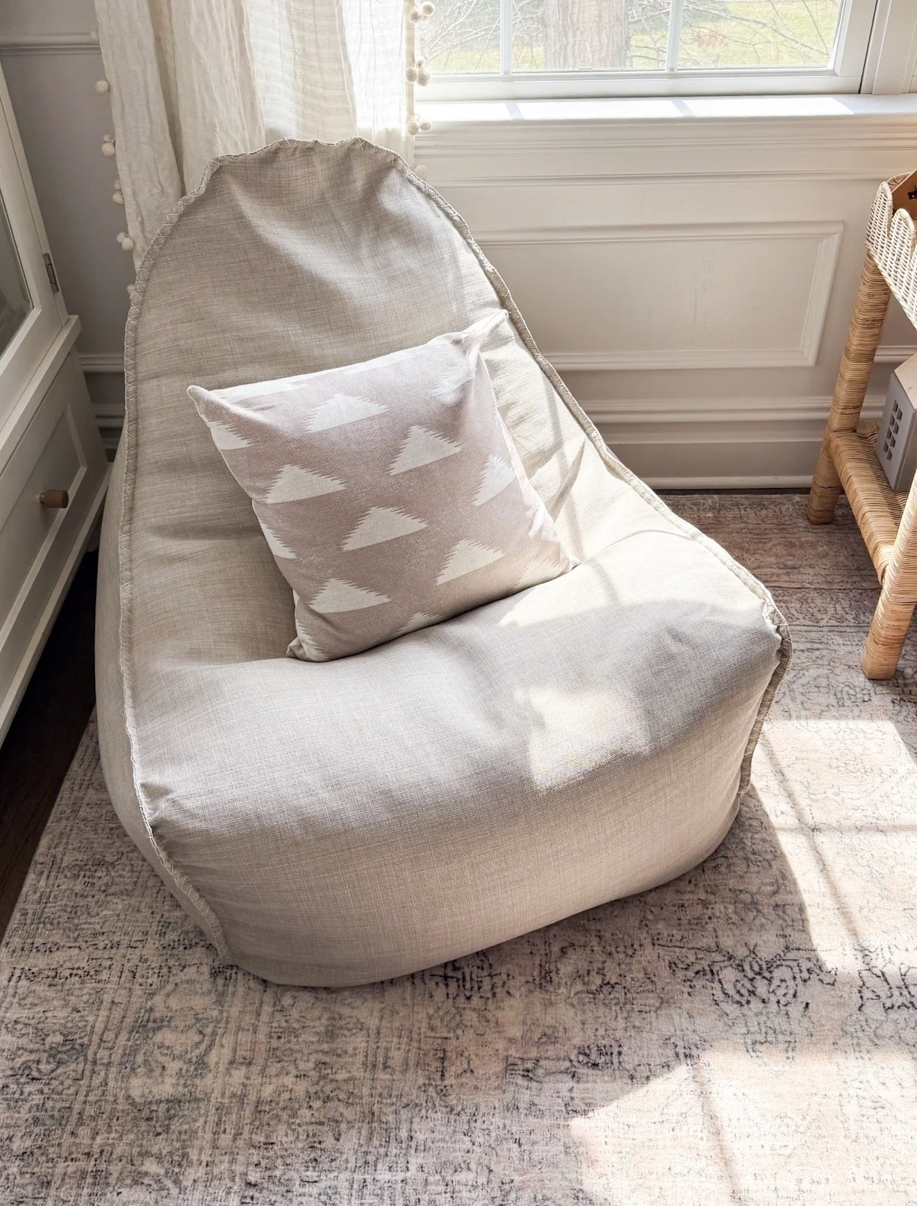 Cozy Serena & Lily upholstered lounger styled in a reading nook with neutral decor and layered textures.