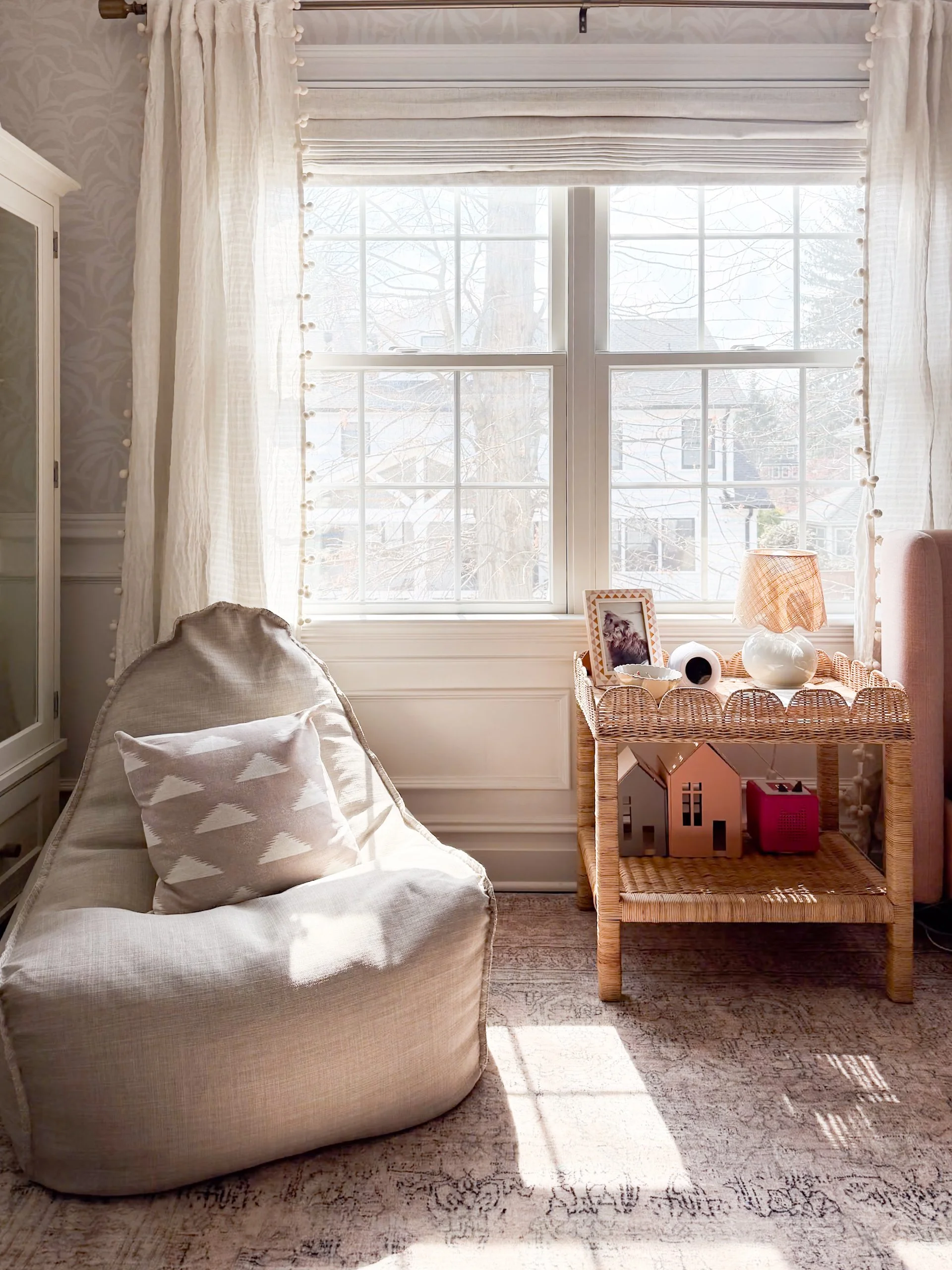 Cozy kids' reading corner with comfortable seating, soft textures, and thoughtfully styled children's room décor.