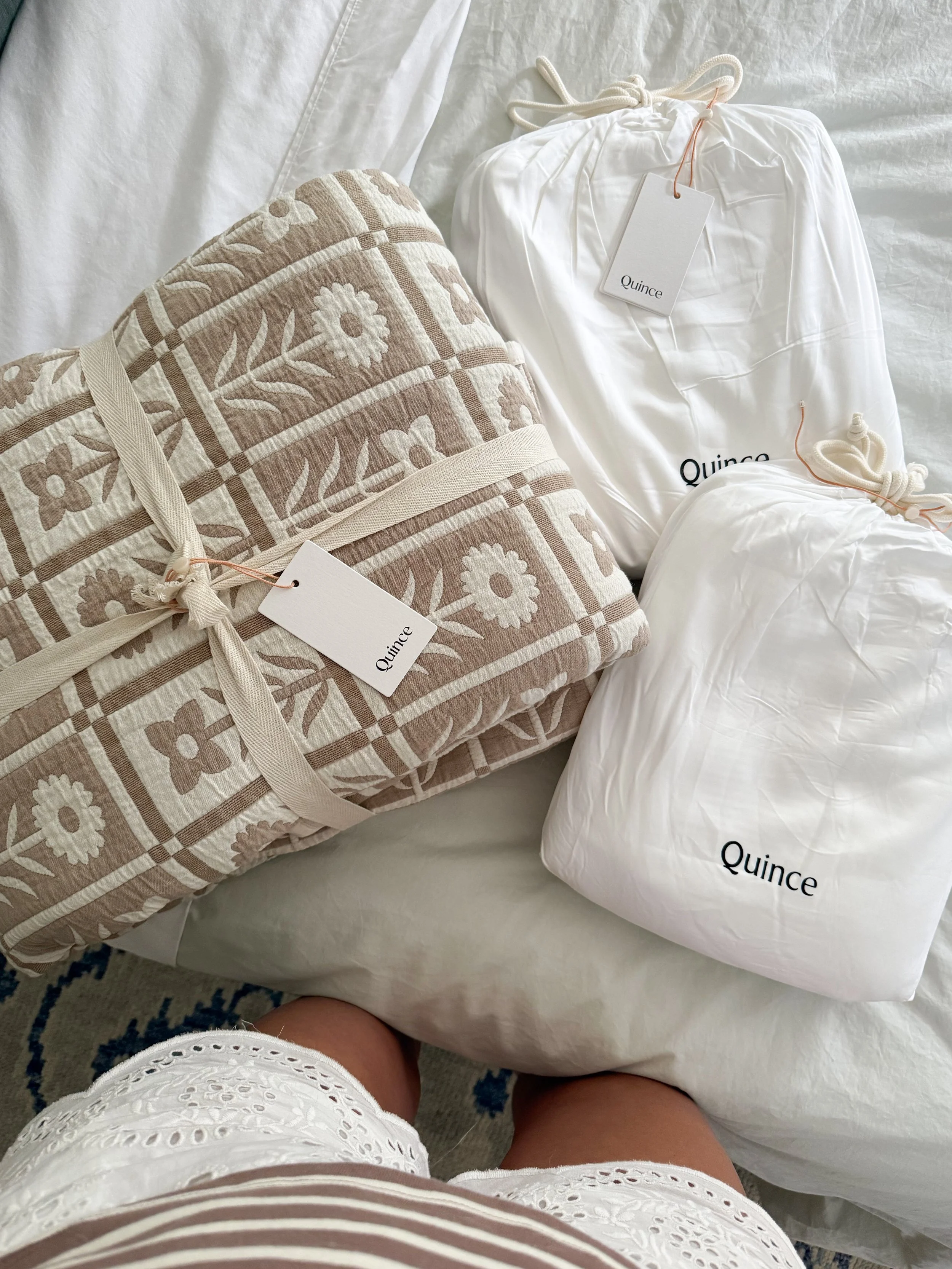 Beautifully packaged Quince bedding before styling the bedroom, featuring premium home essentials ready to unbox.