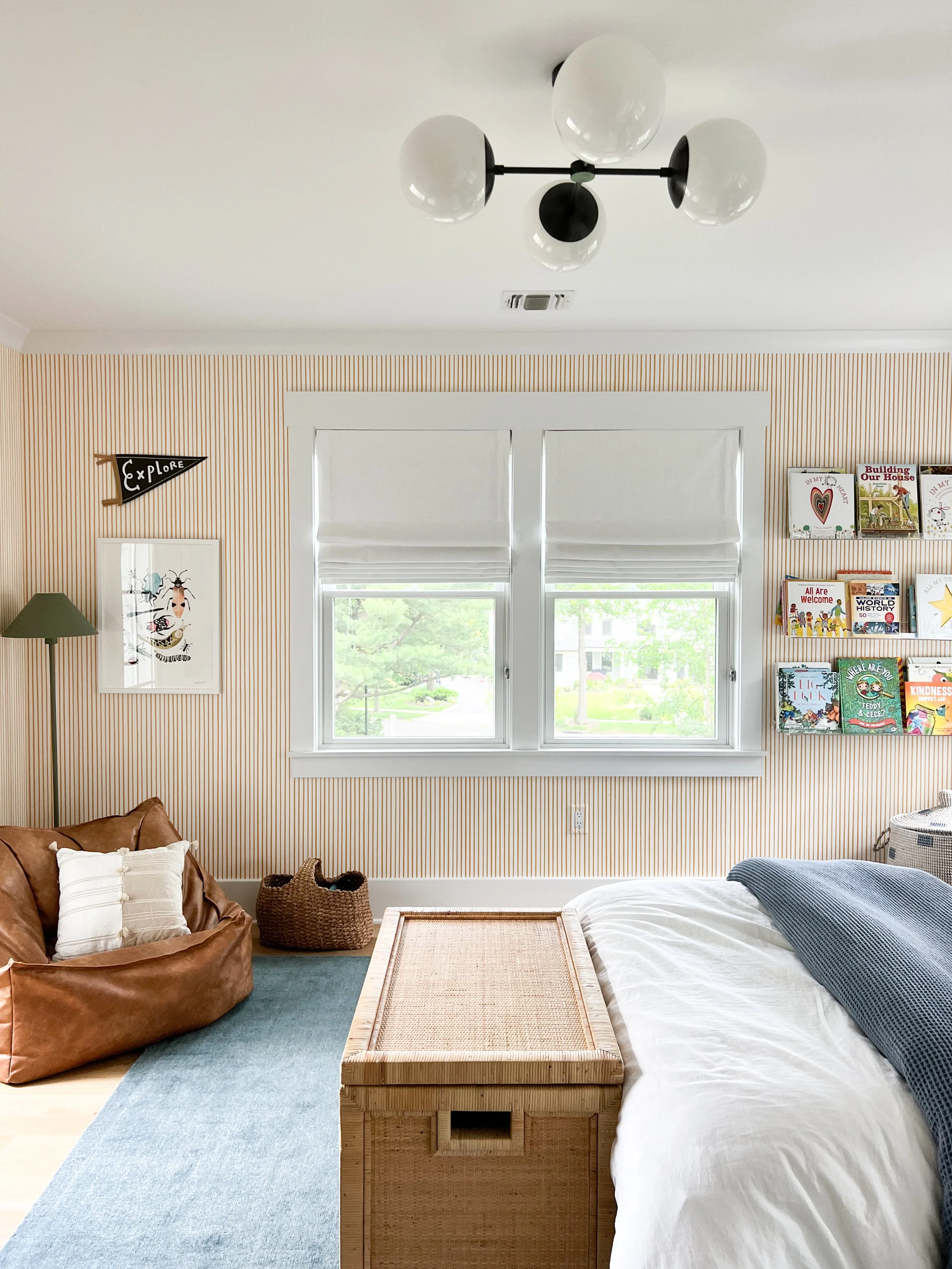Cozy tween bedroom corner with a comfortable lounge chair, layered textiles, and warm home décor.
