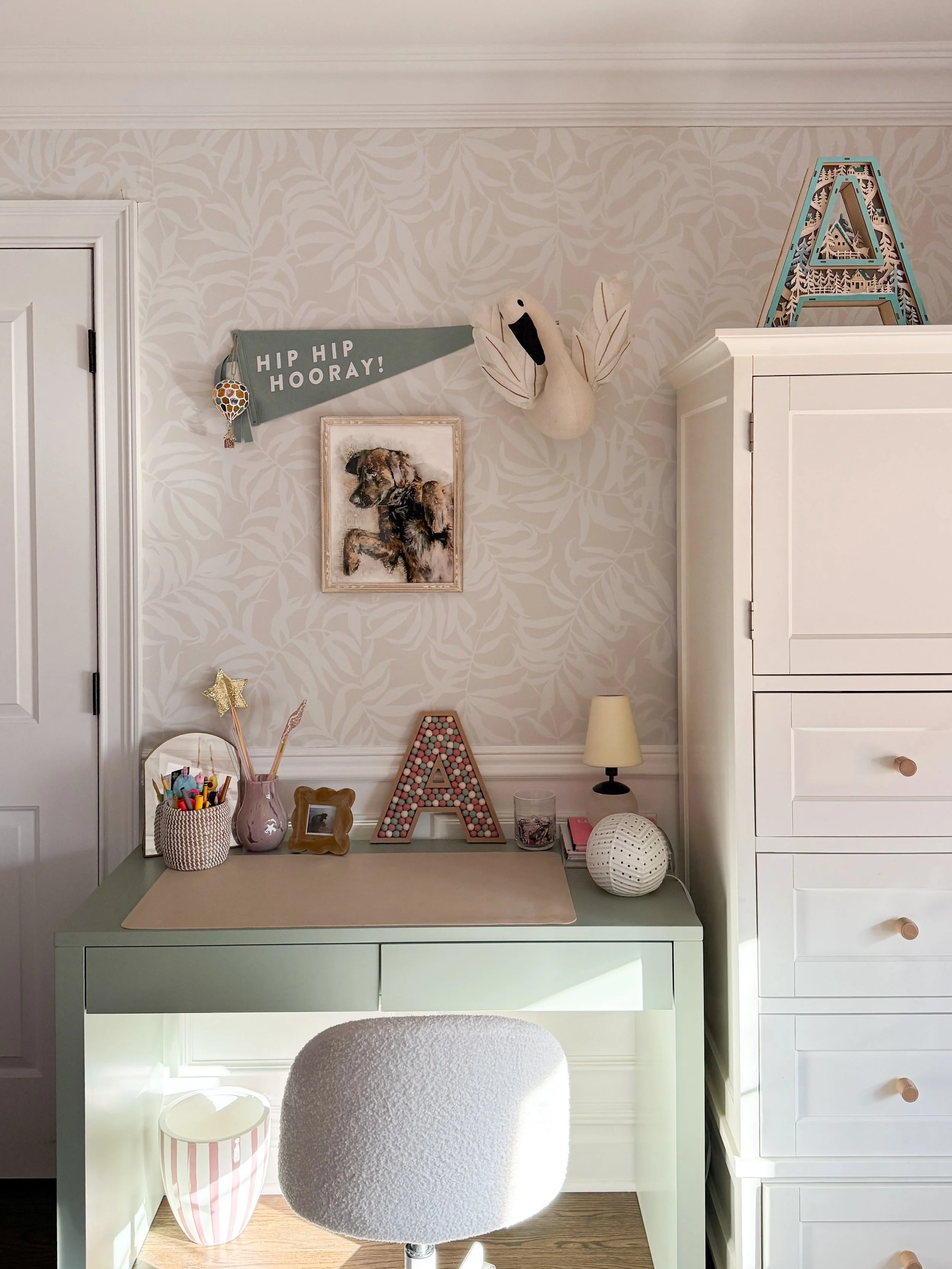 Kids room desk styling with neutral leaf wallpaper, mint desk, and playful decor accents