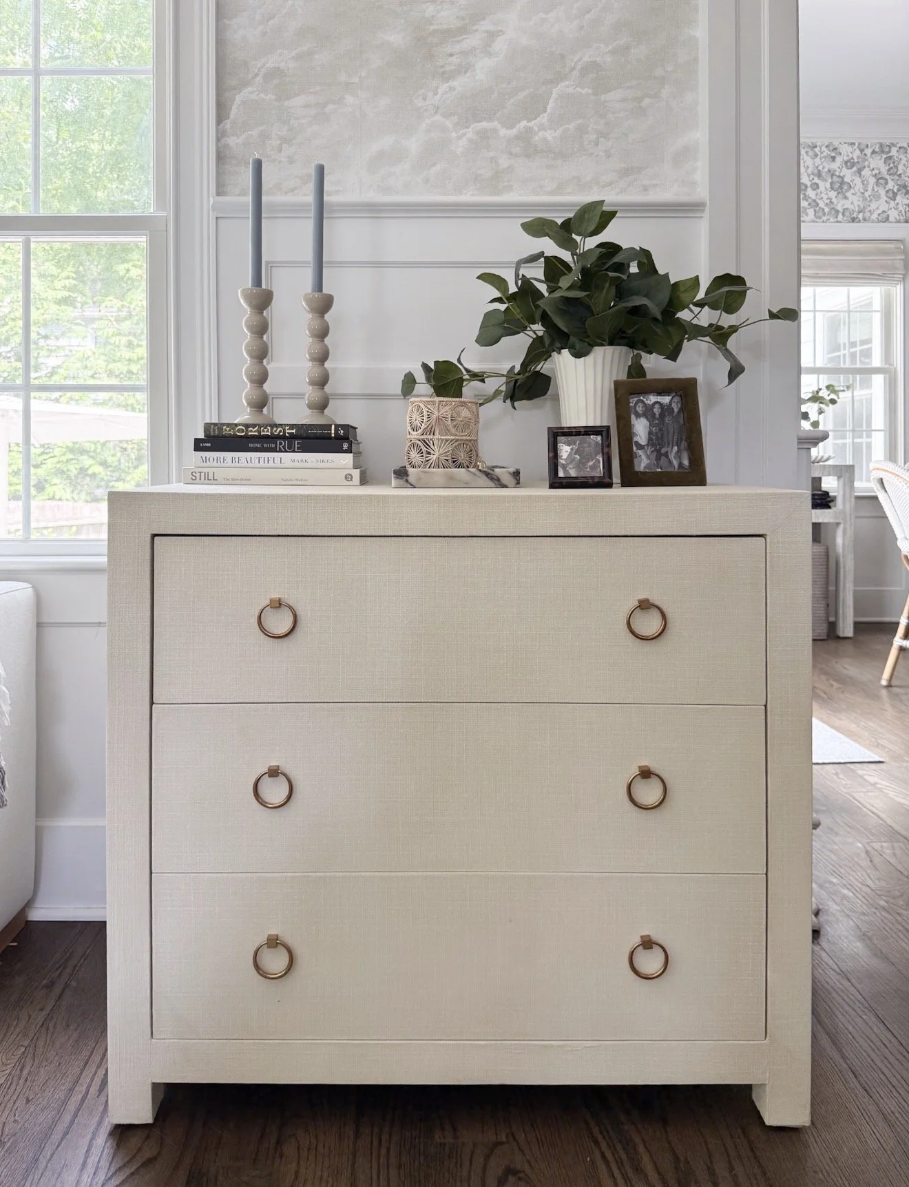Serena & Lily Driftway chest styled with a table lamp, greenery, books, and decorative accessories in a light-filled room.