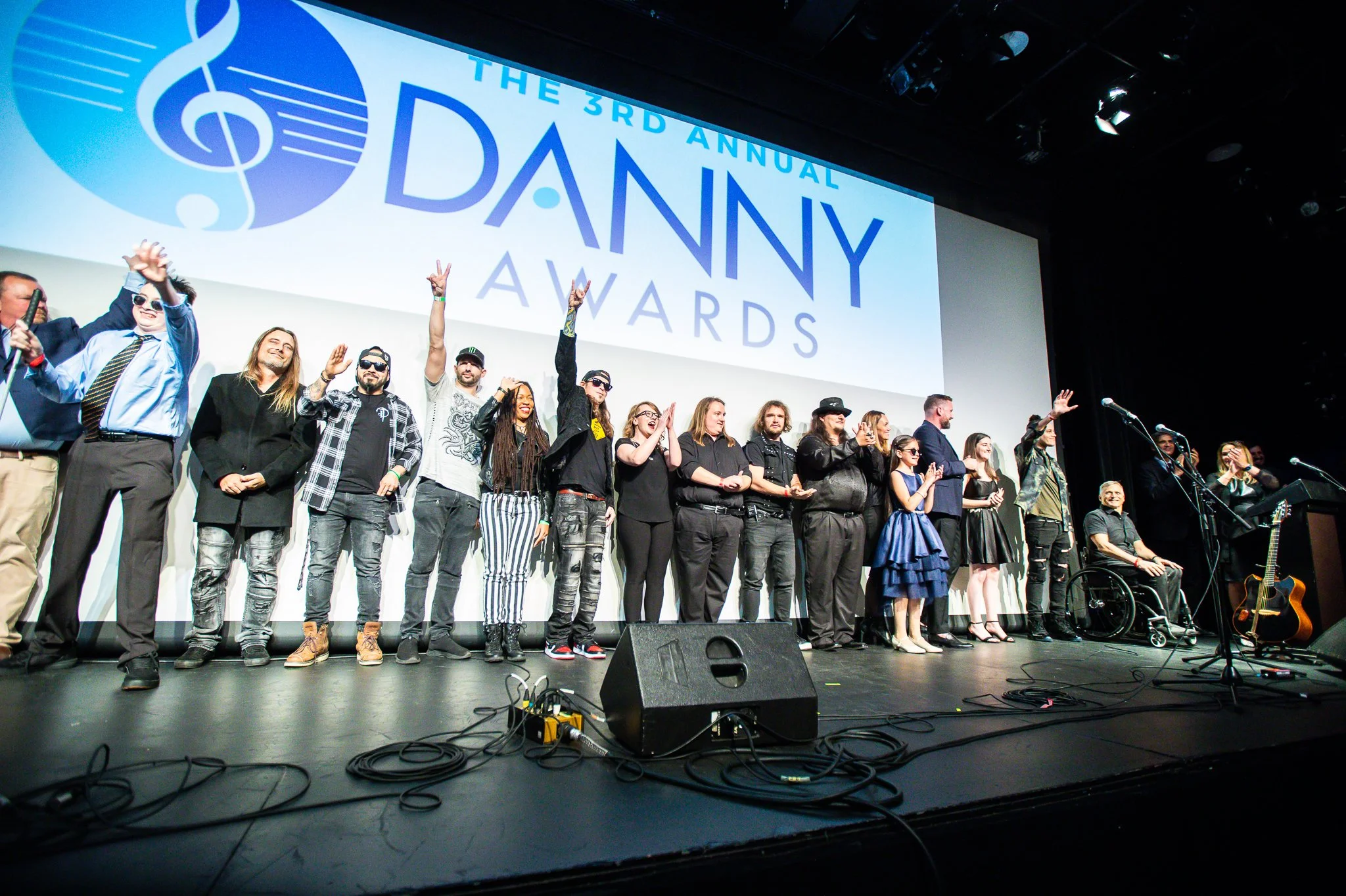  Image of a curtain call at the Danny Awards show, featuring all of the performers in a line-up on stage. 