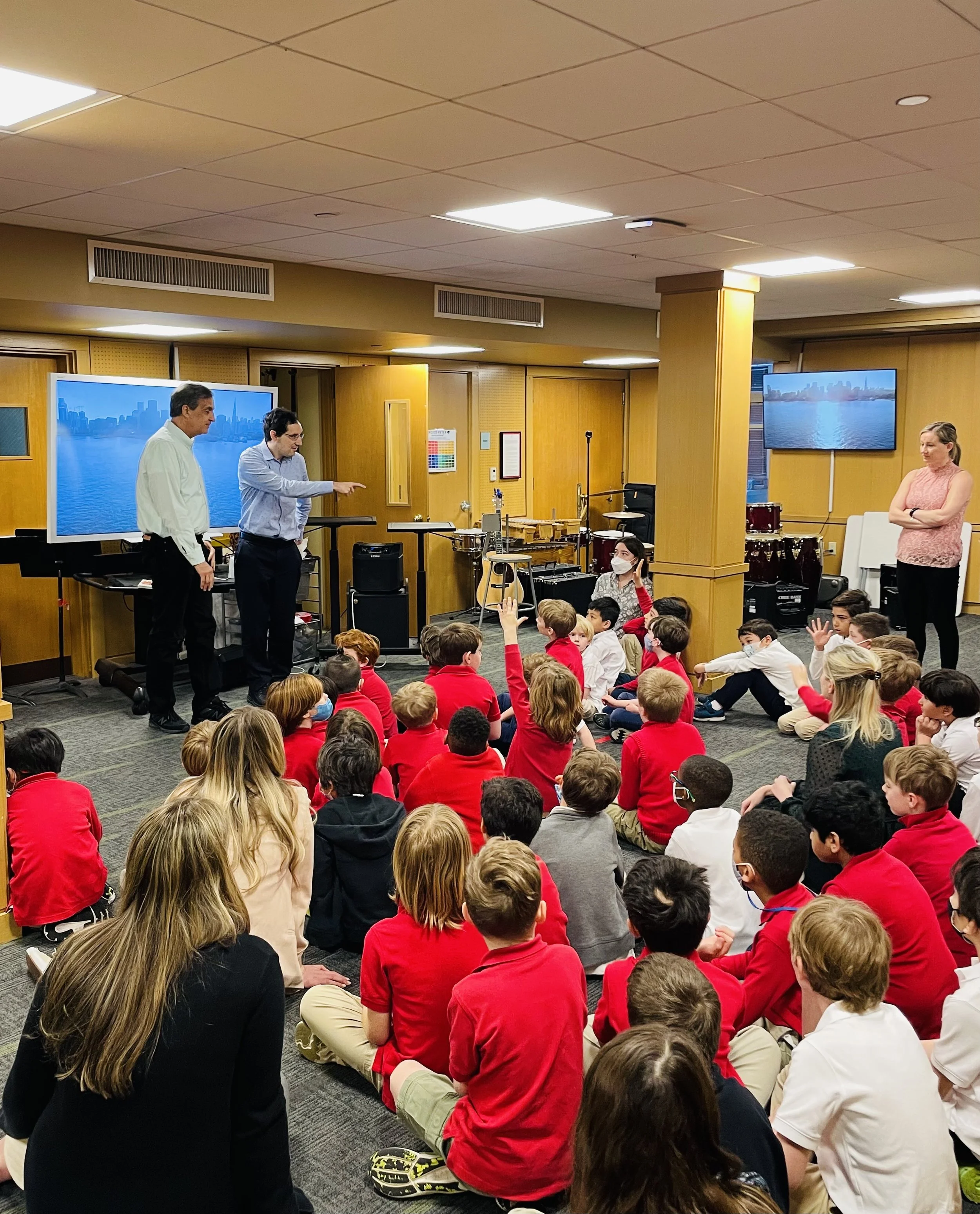  Image of Daniel &amp; Ken leading a discussion on disability awareness in front of a room filled with young students.  