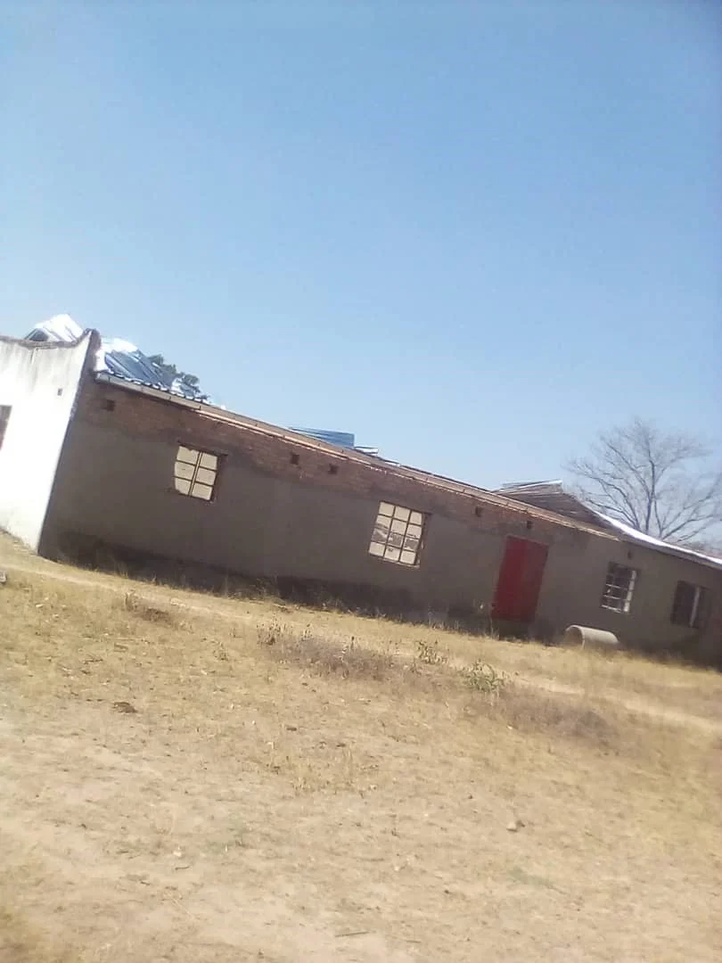 Marumbi school and community hall with roof lifted by the strong winds