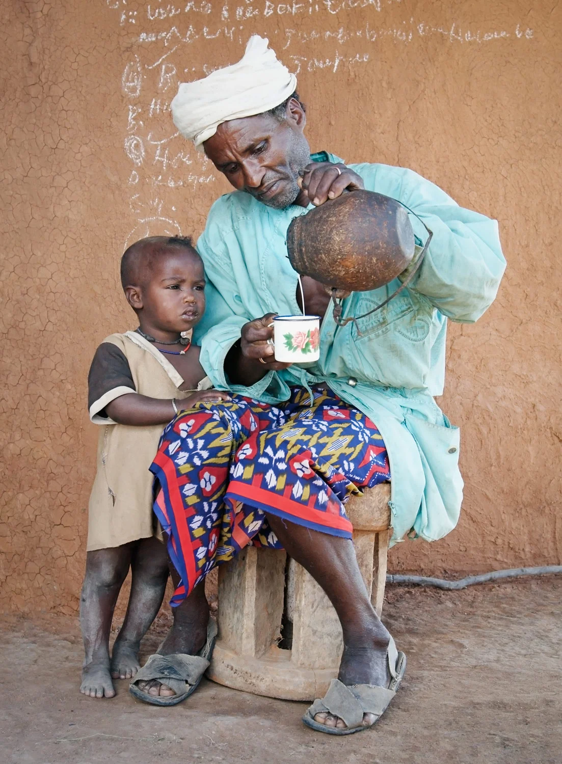 ethiopia-pastoralist-man-child-milk.jpg