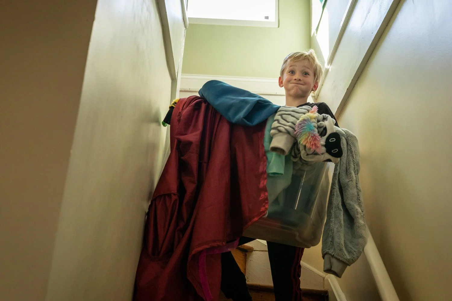 preteen-boy-carries-laundry-downstairs.jpg