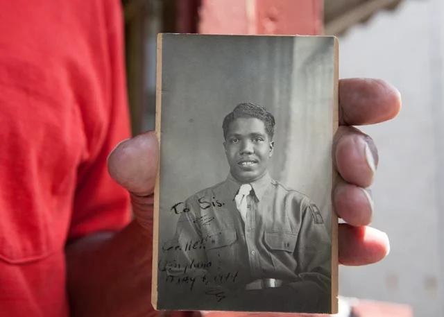 Albert Grillette Wood holds his wartime portrait. Photo: Linda Hervieux