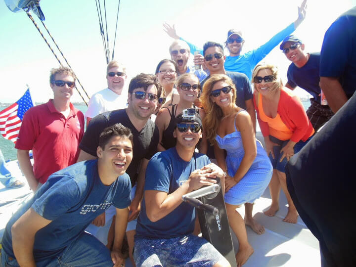 Dan Price (pictured with arms raised) owns a yacht that costs upwards of a quarter million new