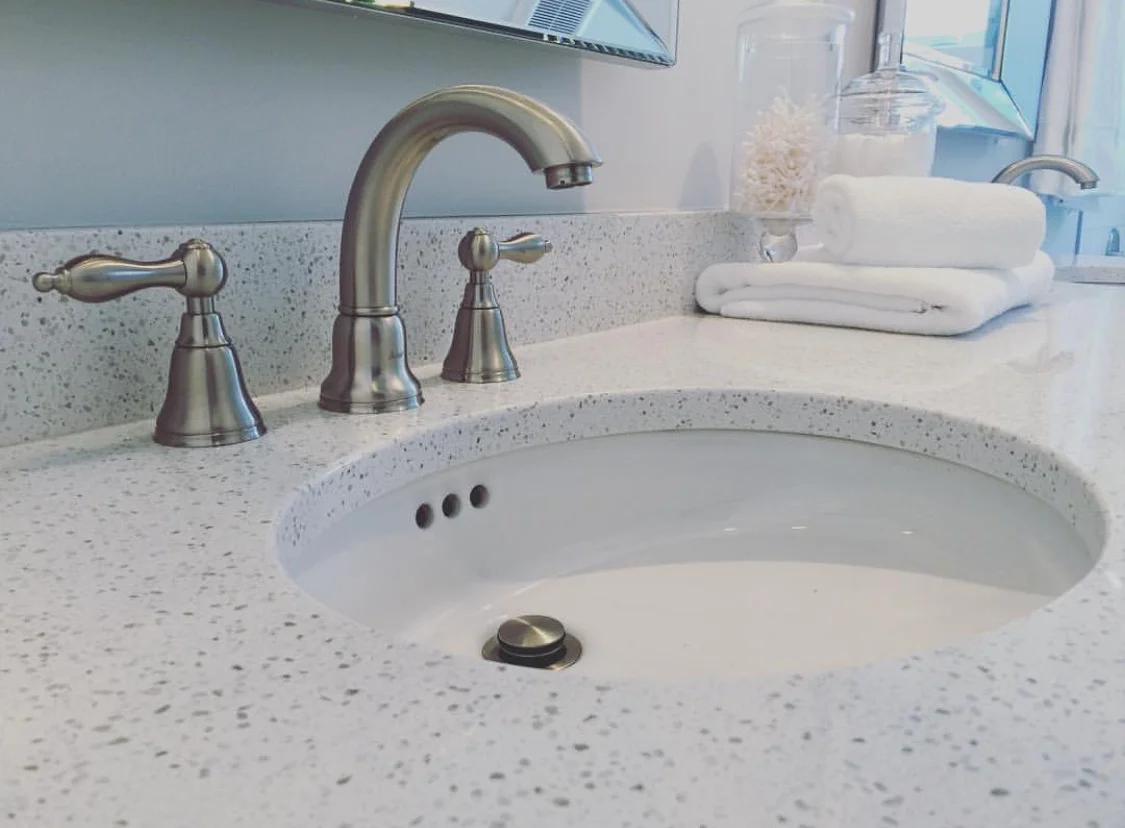 bathroom vanity with Hanstone quartz countertops and undermount white bathroom sink