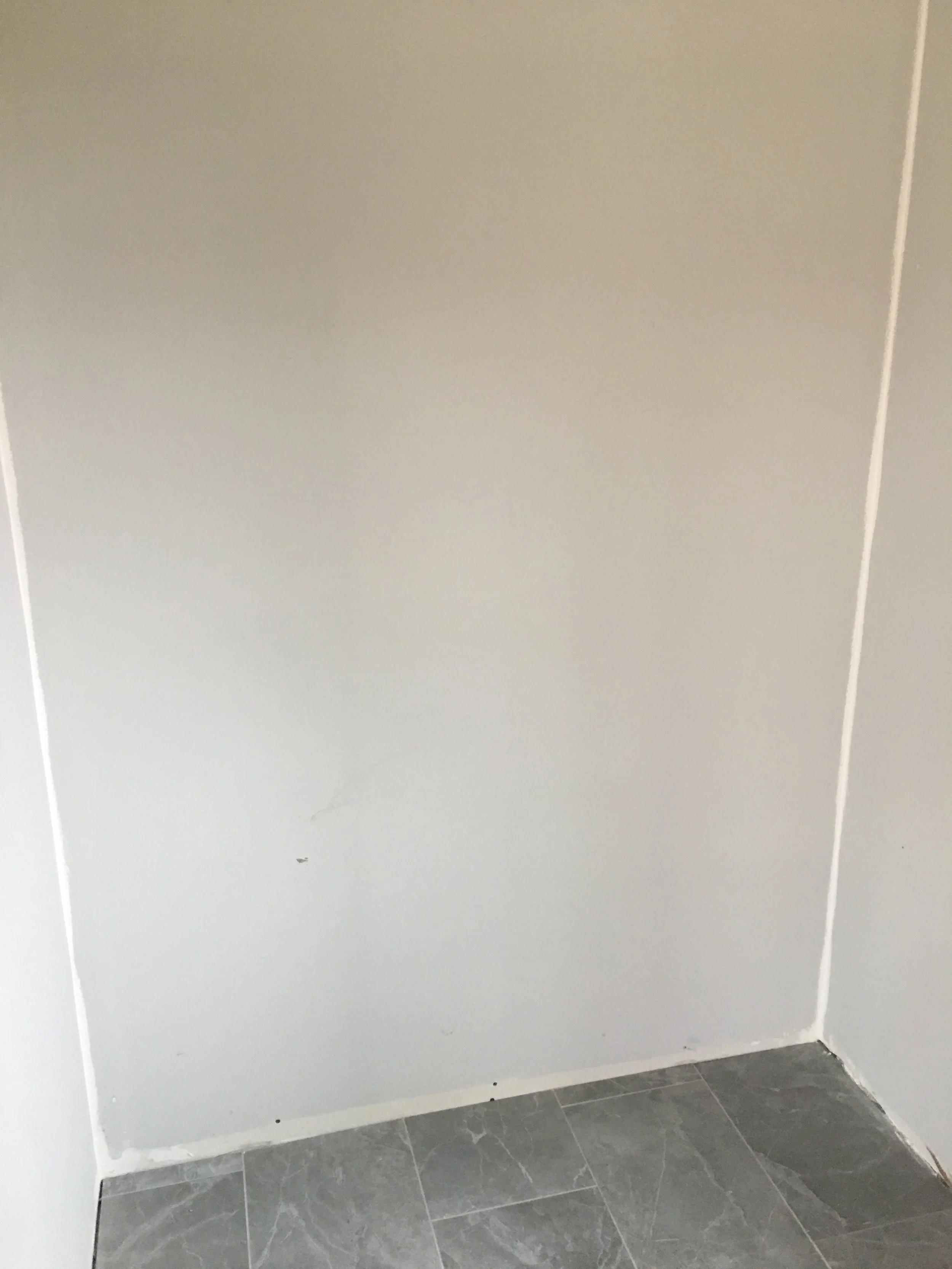 Tiled floor. Before installation of bench