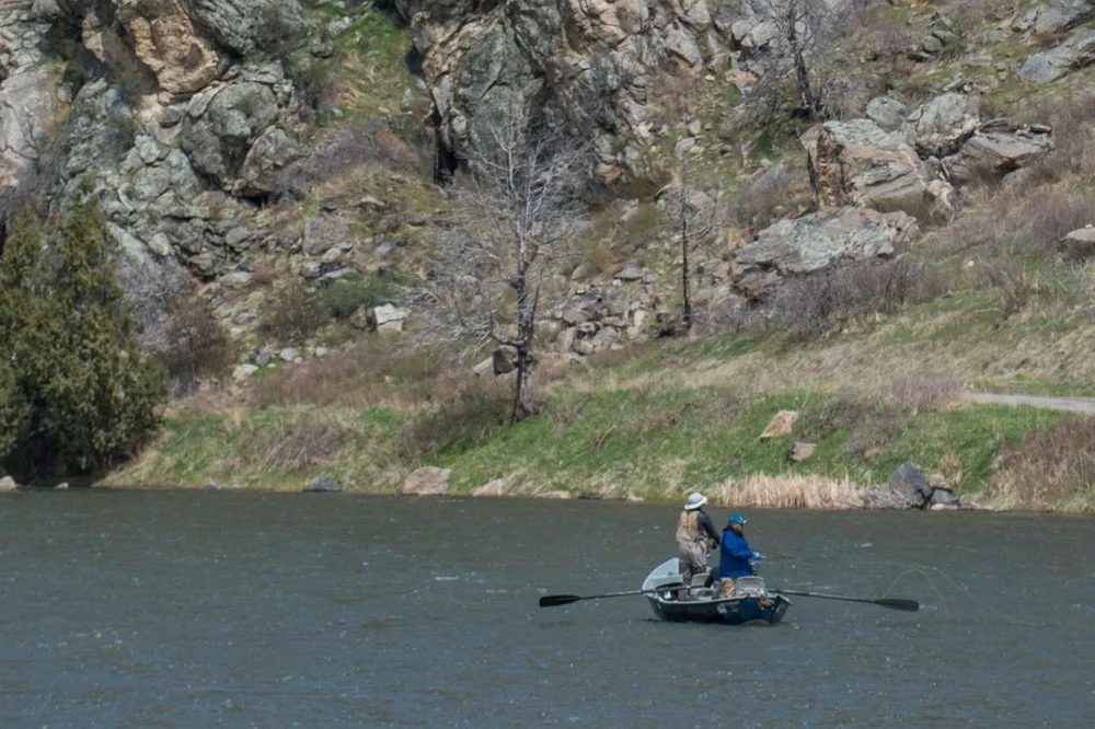 Drift boat fly fishing the Madison River canyon near Ennis, Montana — a strong early season option for guided trips out of Livingston and Bozeman.