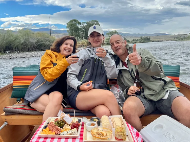 Family enjoying charcuterie and drinks on a private scenic float on the Yellowstone River near Livingston Montana
