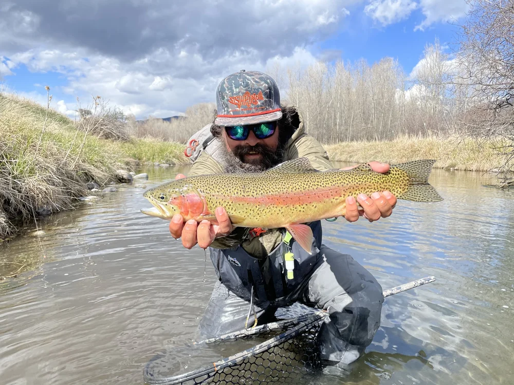 Angler holding a rainbow trout on DePuy's Spring Creek