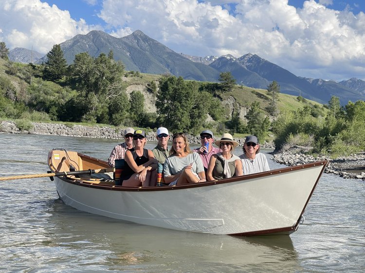 Wooden dory drifting the Yellowstone River below the Absaroka Mountains