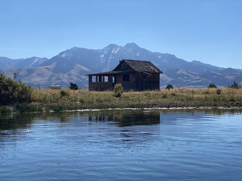 Rowboat with anglers on Story Lake, a private ranch lake near Livingston, Montana.