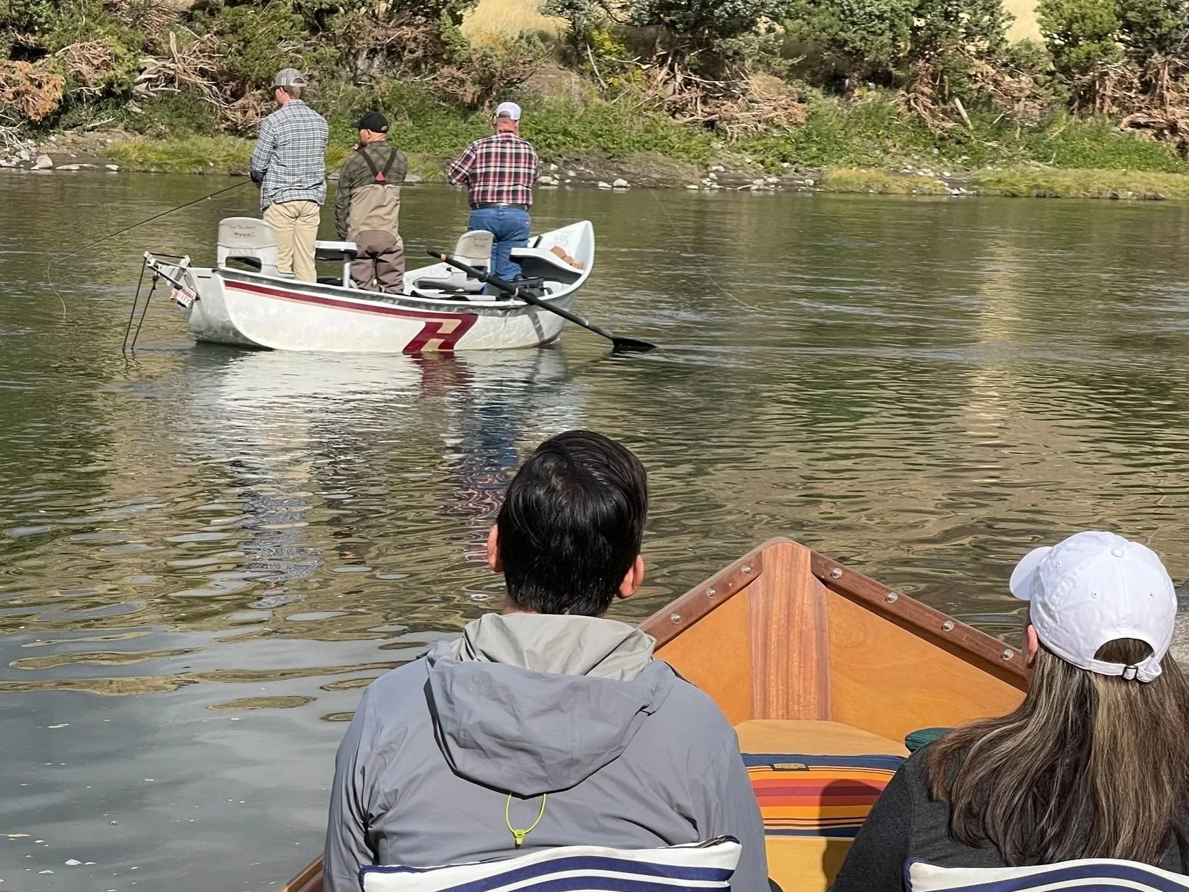 Fishing dory and wooden scenic boat side by side on a hybrid Yellowstone River trip near Livingston Montana.